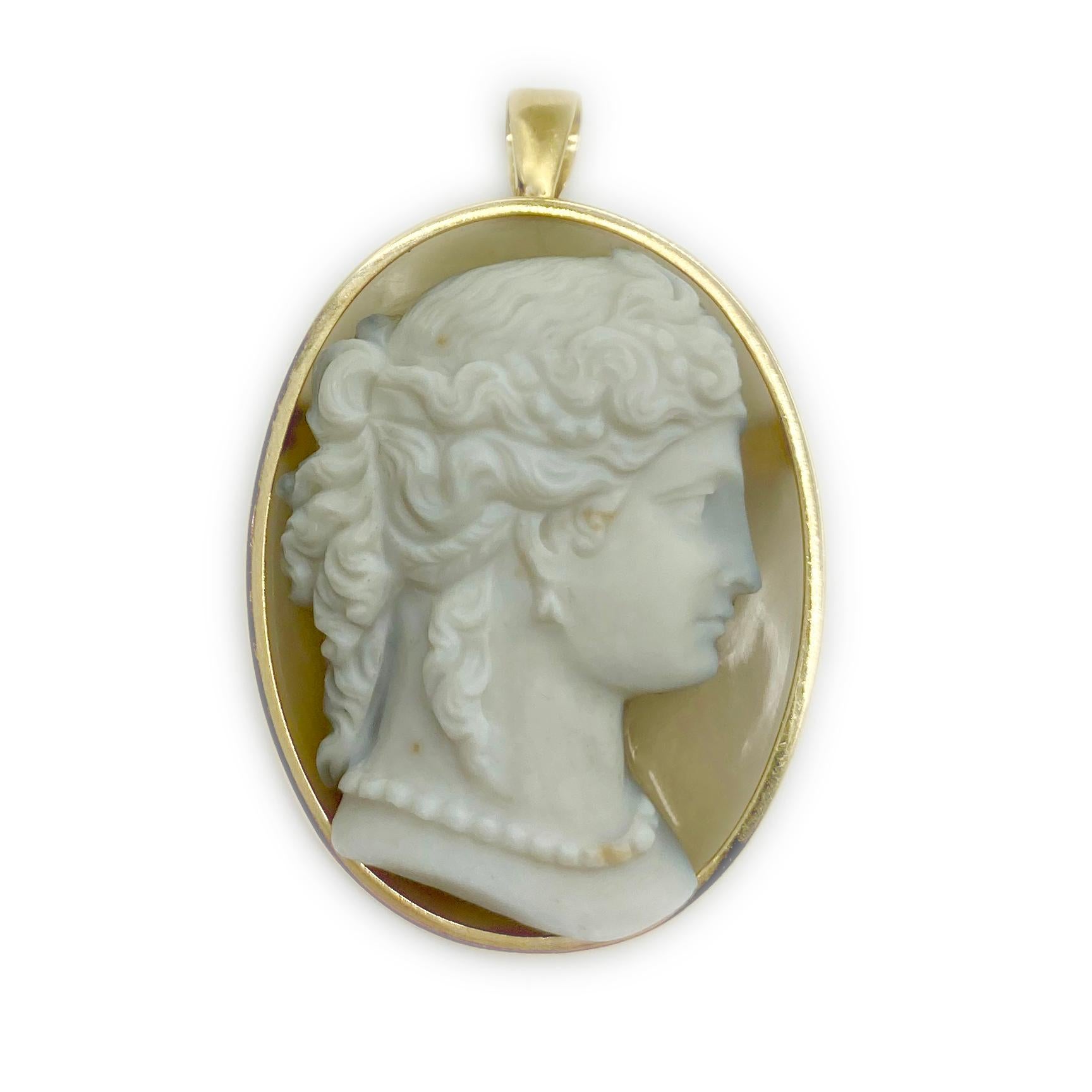 An antique cameo carved from agate, mounted as a pendant-brooch. 19th Century.