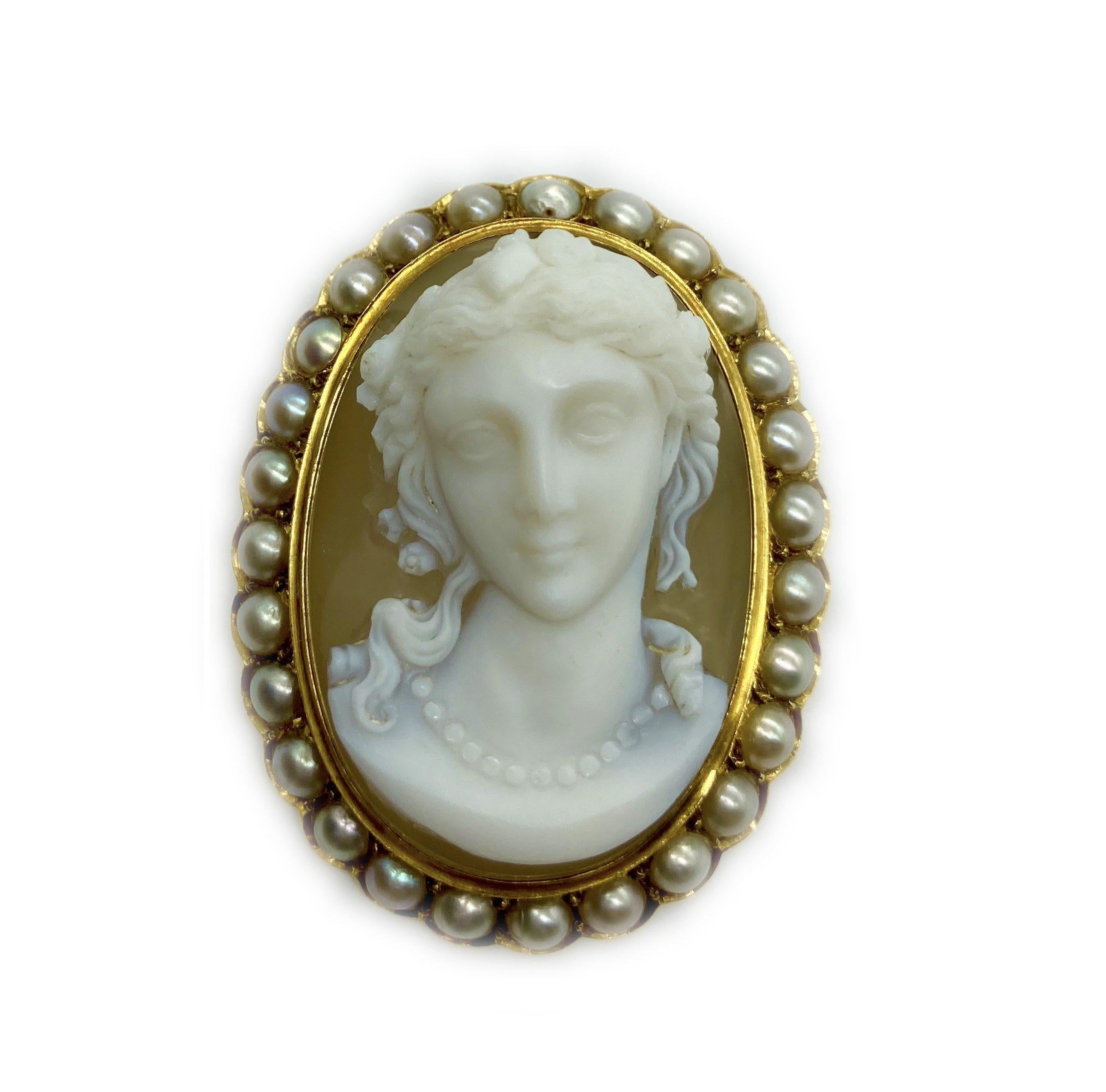 Eine dreidimensionale antike Brosche mit einer weiblichen Büste, die von einem Achatkern ausgeht und mit Perlen eingefasst ist.