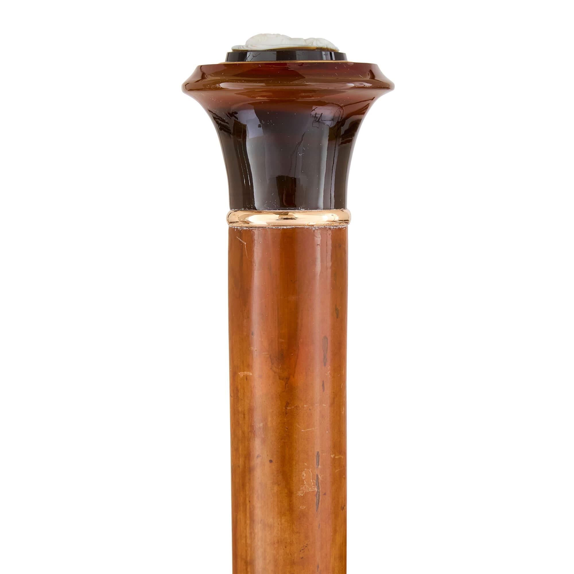 Antique agate mounted and cameo inset walking stick 
Continental, c. 1900 
Height 91cm, diameter 5cm

Expertly fashioned in around 1900, this exquisite walking stick is crafted from premium materials, with earthy hues that blend harmoniously.

The