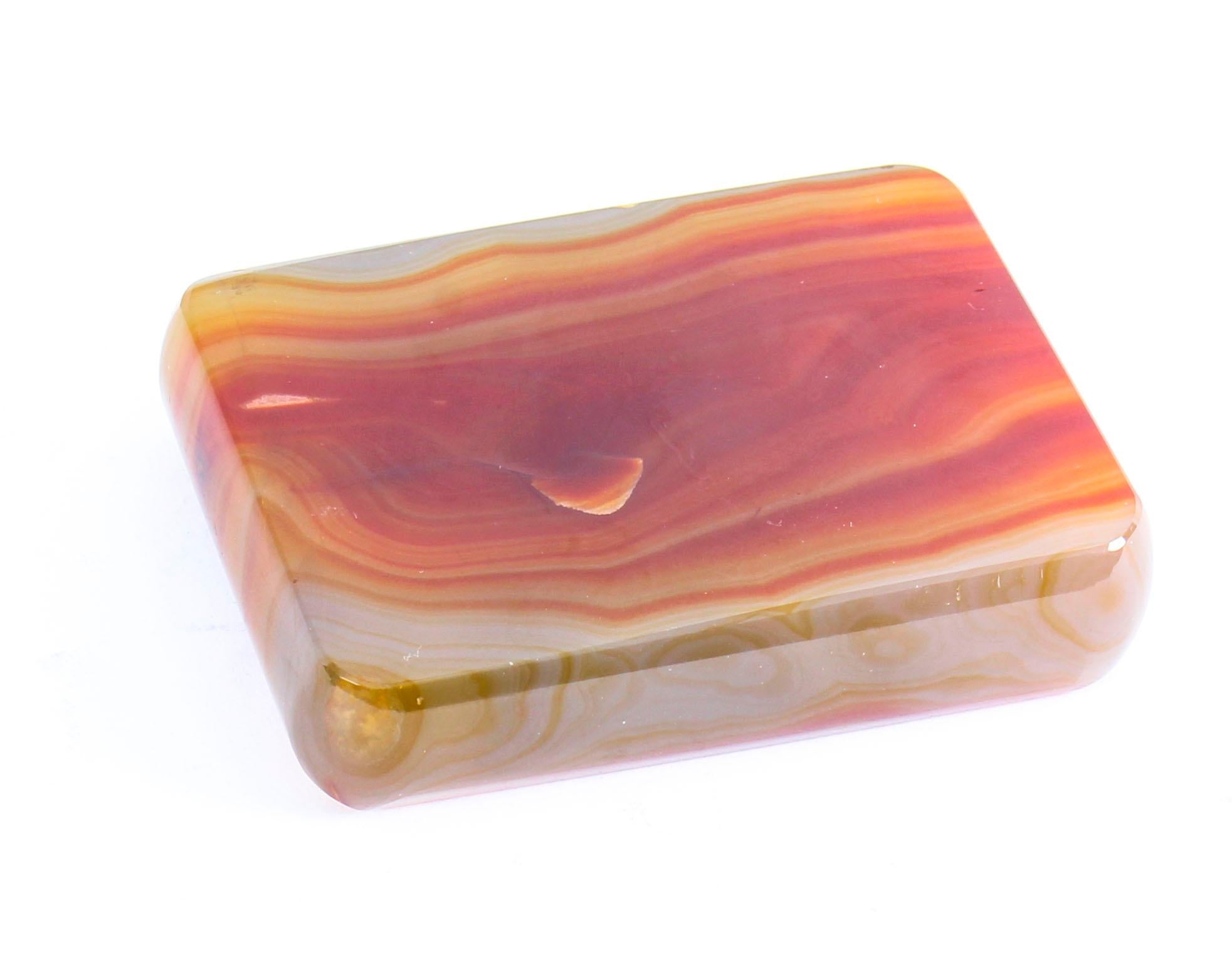 This is a wonderful antique agate desk paperweight, circa 1880 in date.

The paperweight is rectangular in shape with rounded corner and features beautiful alternating bands of red, gray and yellow colors. 

Add an elegant touch to your desk