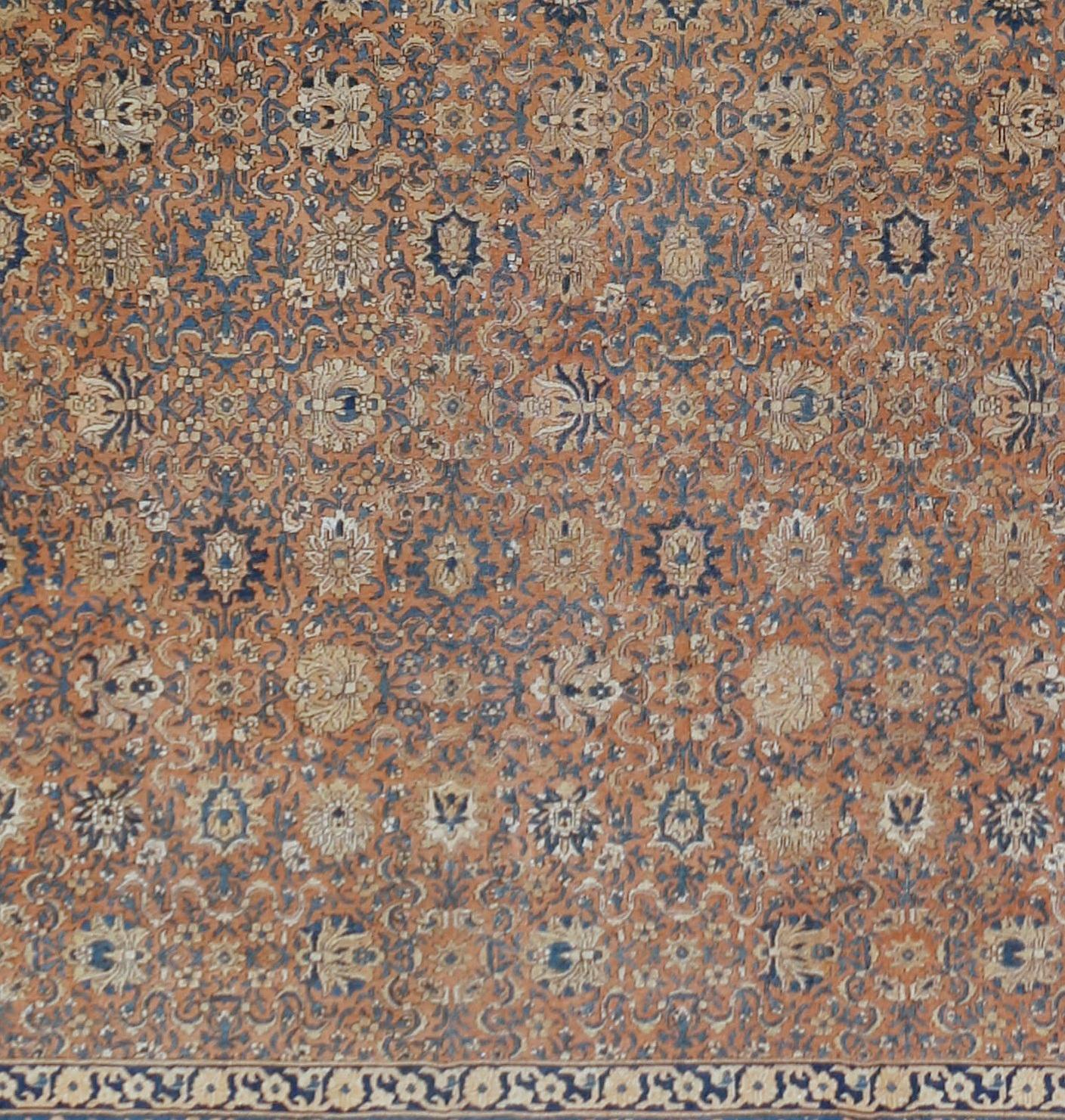 Antique Agra carpet, circa 1890 10'4 x 17'. This fine antique Agra carpet is a creative interpretation of an early 16th century Persian piece. The pattern is very dense in both field and border. The rust ground is closely covered by cloud bands and
