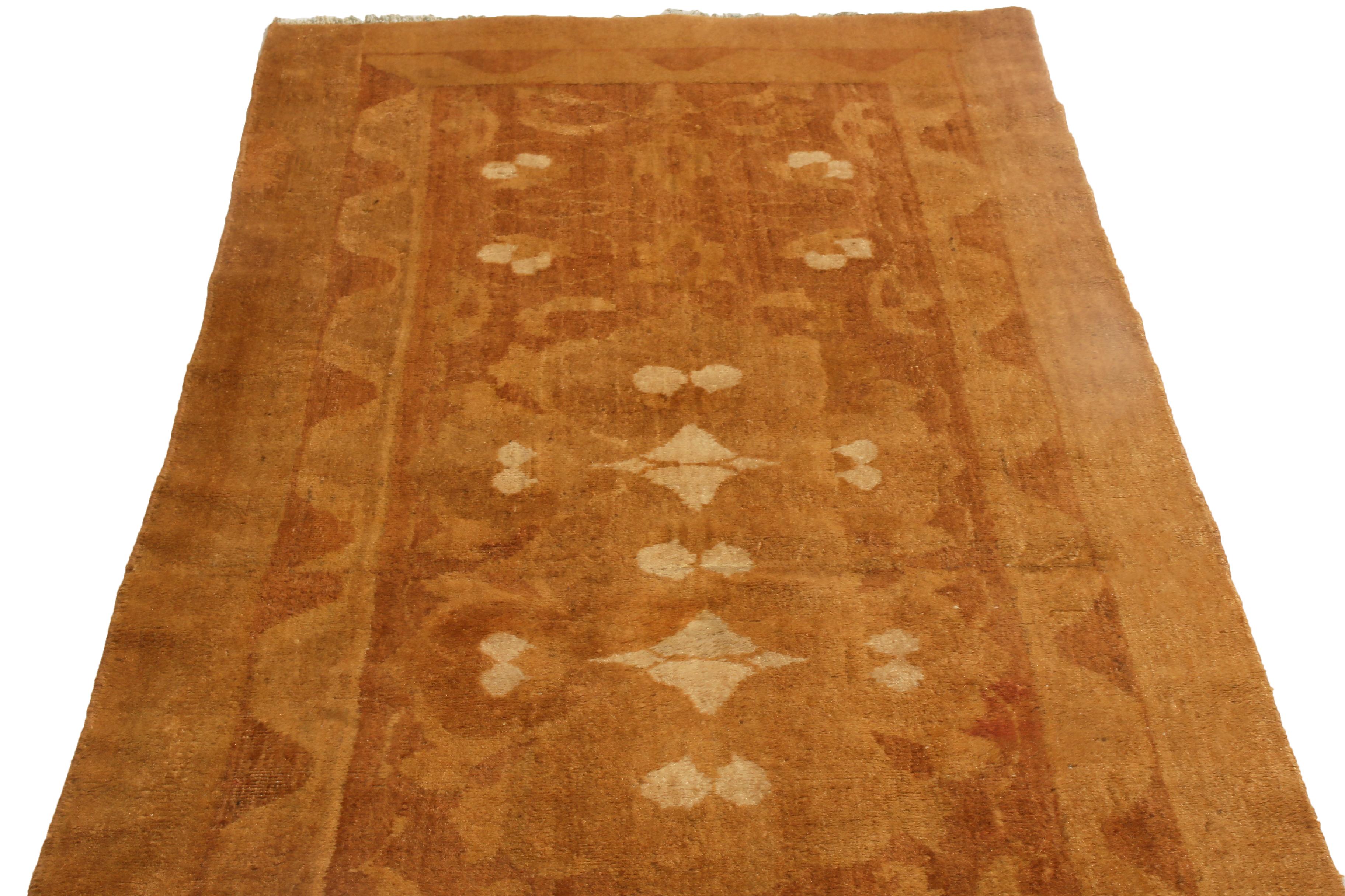Originating from India, this antique Agra runner is hand knotted hails from a select family with a particularly luminous, high quality wool body, featuring a uniquely minimalist geometric-floral pattern in a multi-bordered, perfectly mirrored field
