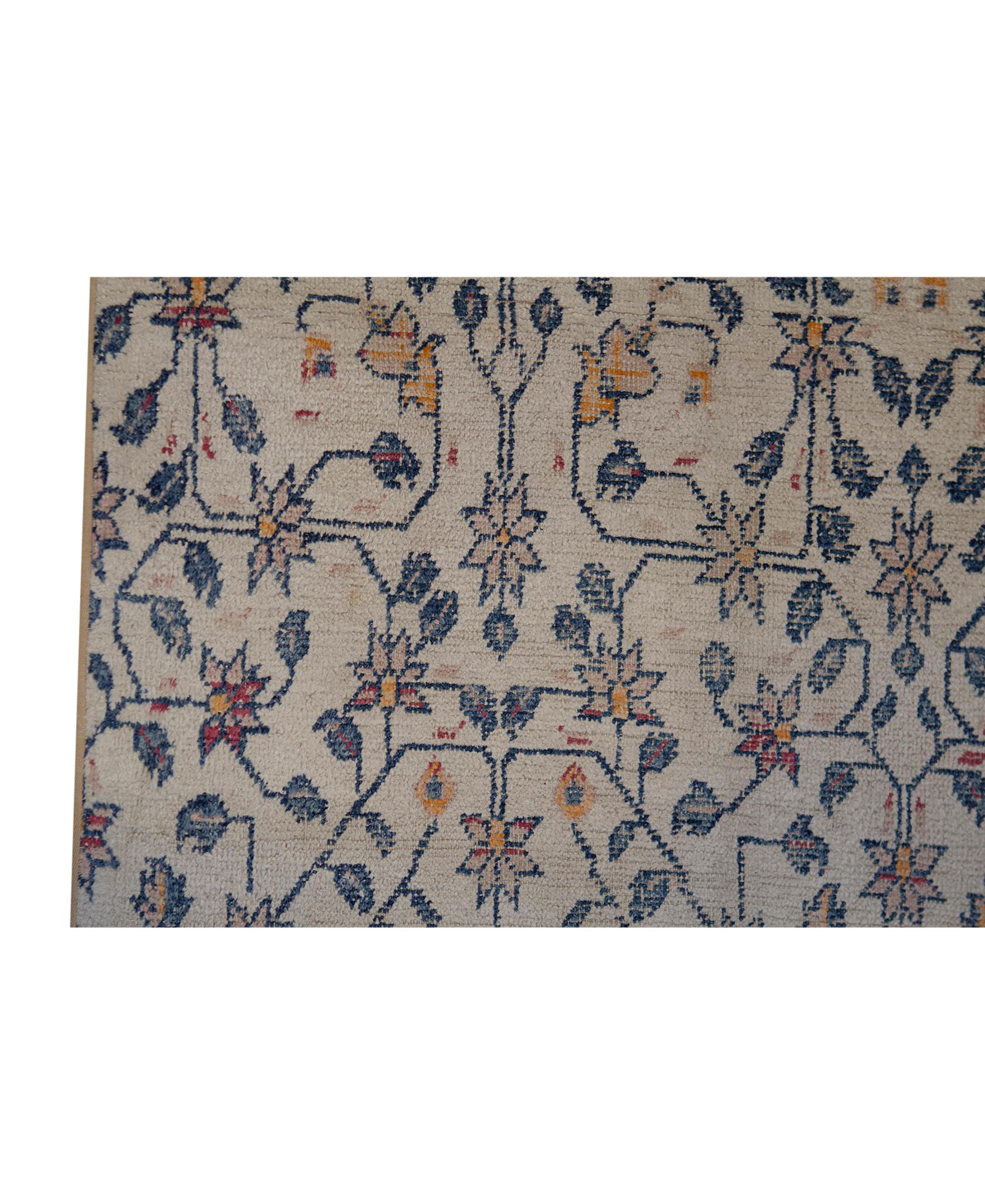 Antique Indian hand woven Agra Fragment Ivory wool rug. A light and interesting design and color combination help translate this rug into a piece that will bring lightness and importance to a room setting. 
