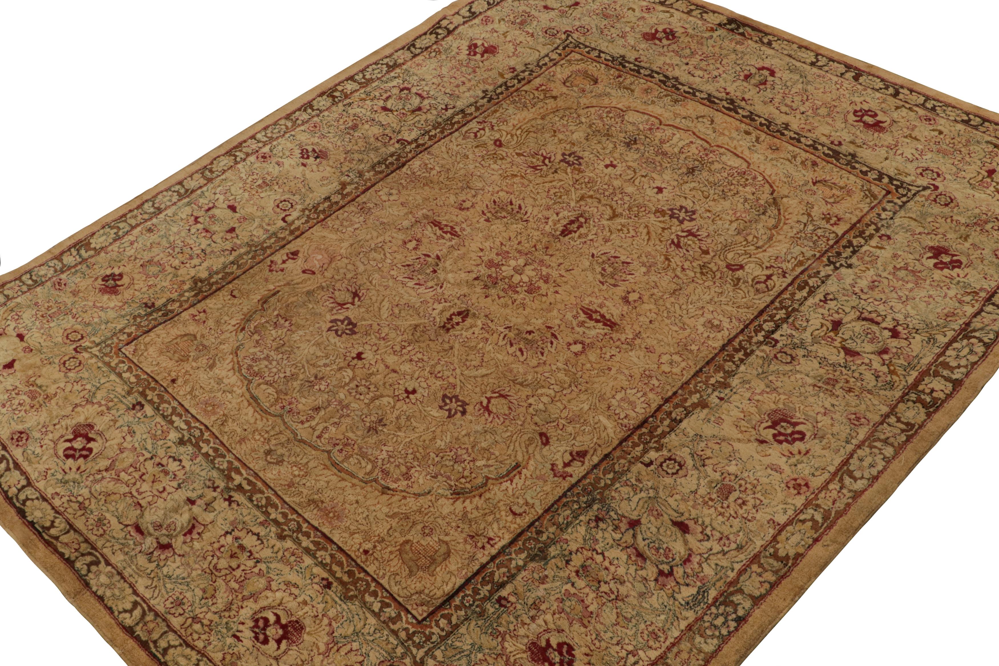 A very special rug for its design and detail for the 19th century period, this 9x11 antique Agra rug, in brown and gold field, with floral patterns in beige, red and green tones, is in a pristine condition, making it a rare masterpiece. 

On the