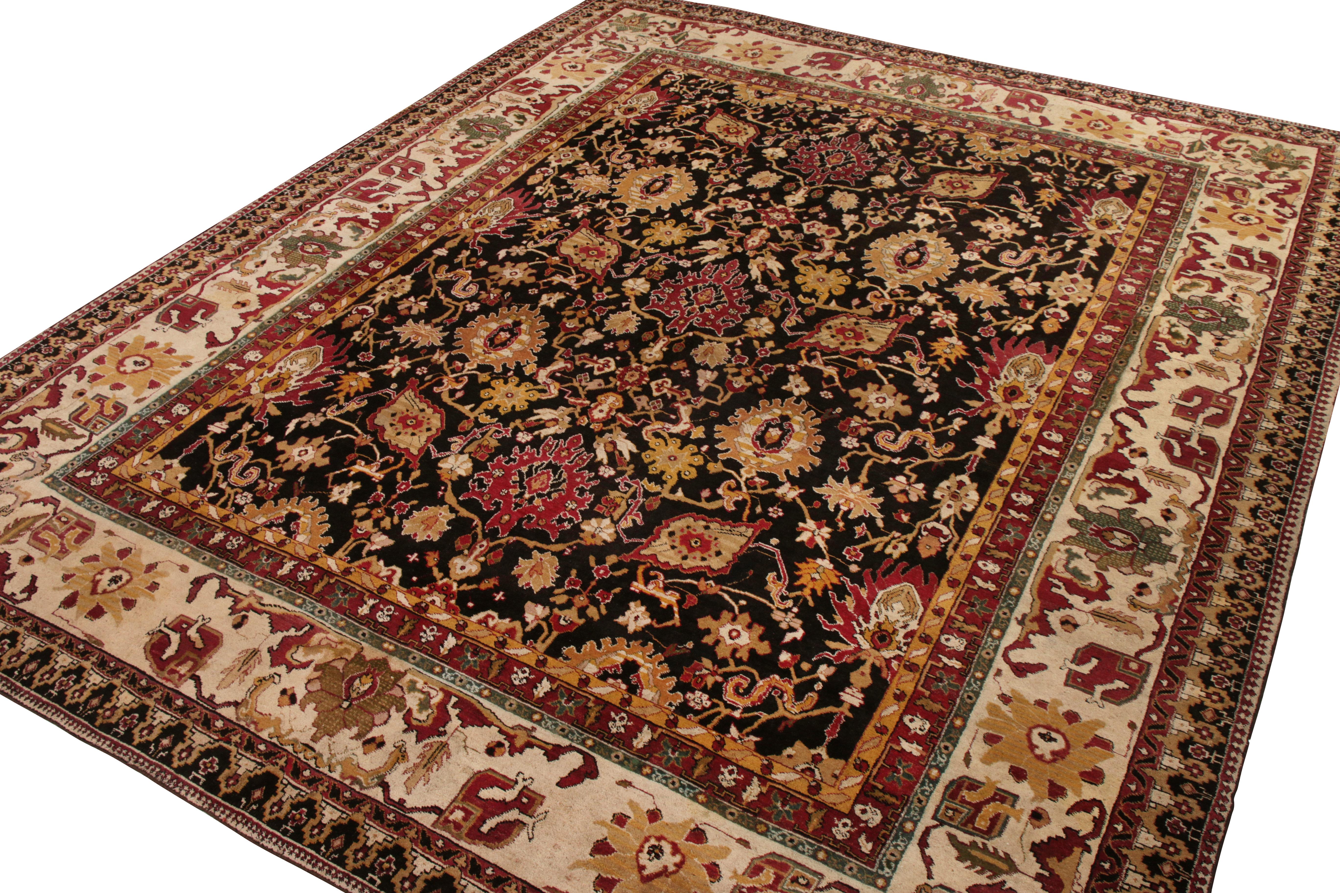 This antique 12x15 Agra rug is a rare oversized piece of its period—hand-knotted in wool circa 1920-1930.

On the Design:

This piece enjoys an all over floral pattern in warm red, gold and beige-brown against a near-black field. Keen eyes and