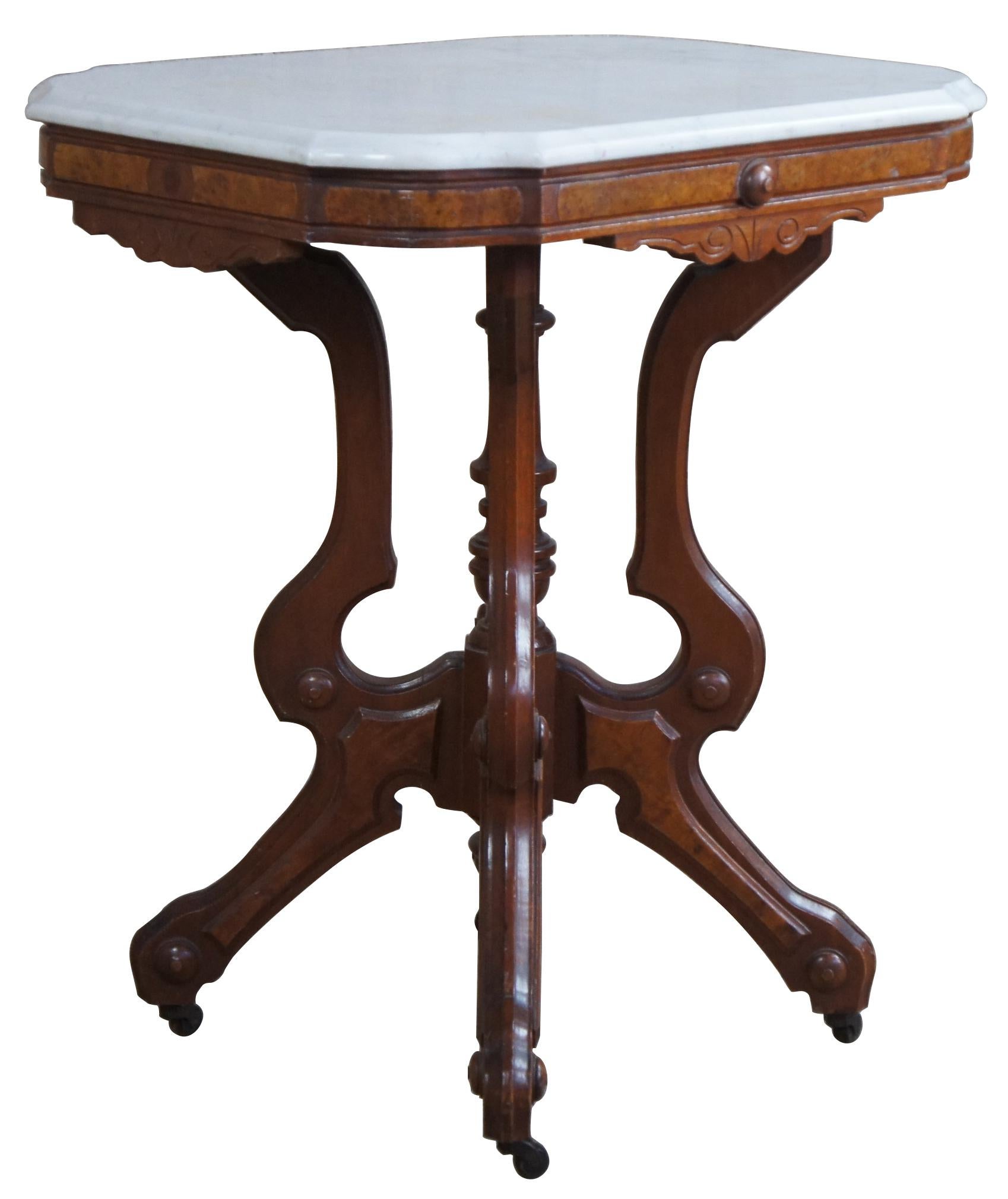Antique Victorian Eastlake parlor table made by A. H. Heilman & Co. Made from walnut and walnut burl panels with an rectangualr shaped white marble top with serpentine corners. Base features a turned center support surrounded by four serpentine