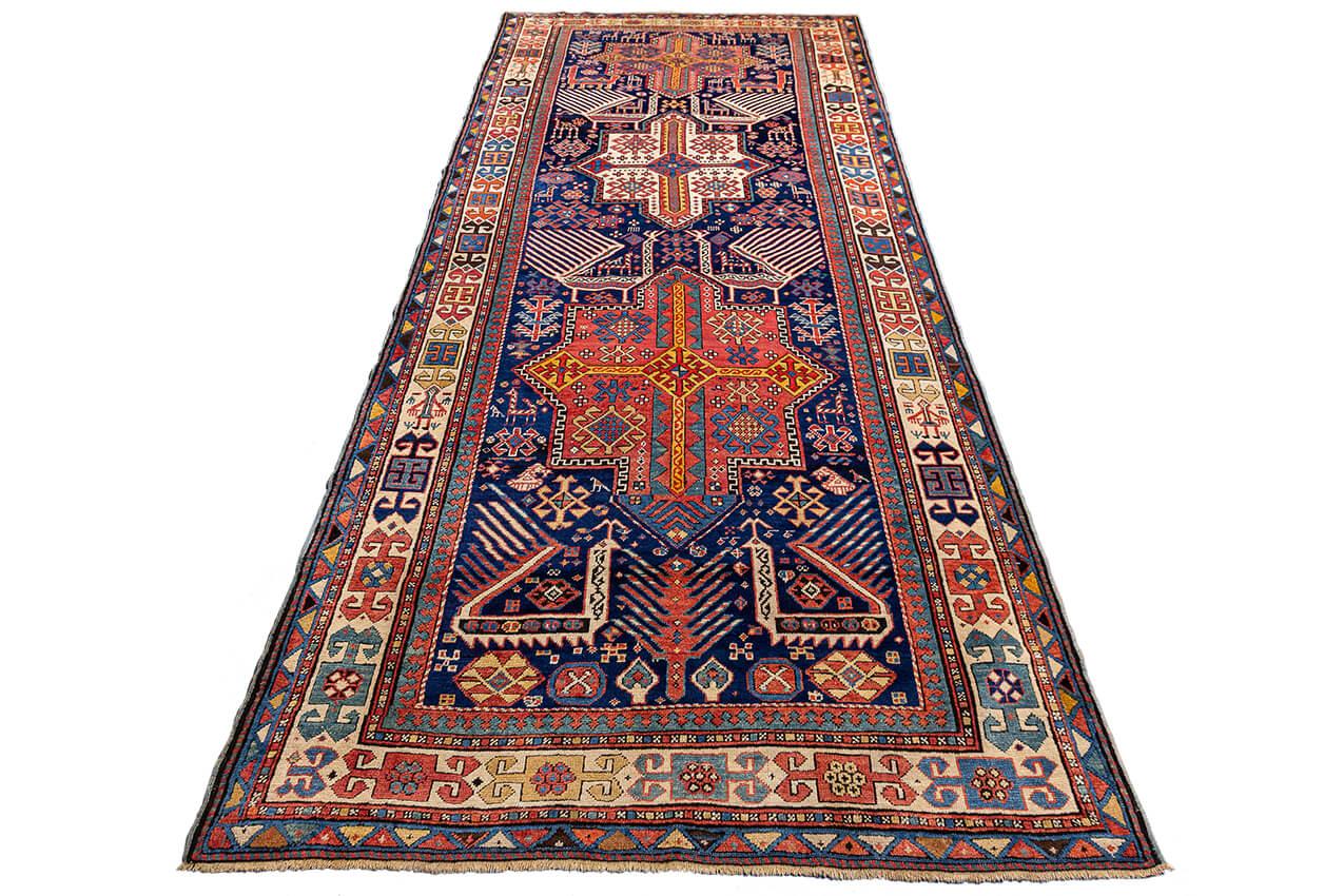 Journey Through Time with this Antique Akstafa Rug (123 x 285 CM): A Masterpiece of Geometric Artistry Embark on a captivating journey through history with this special piece, an exquisite tapestry that marries the world of art and culture.