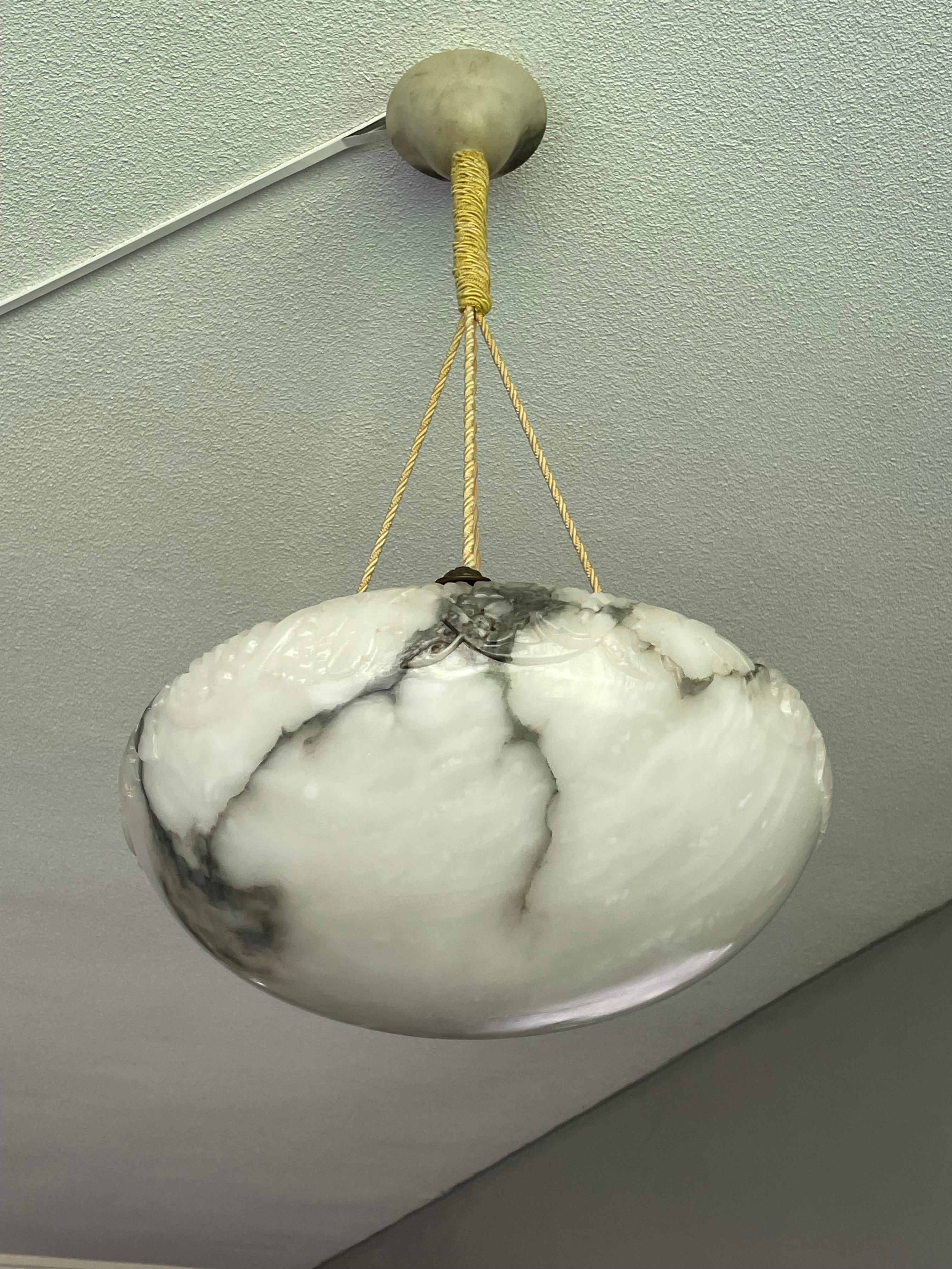 Stunning bowl alabaster chandelier with a perfect rope and canopy.

Thanks to its practical size, its unique handcarved design and superb condition this alabaster chandelier will light up both your days and evenings. What makes this particular