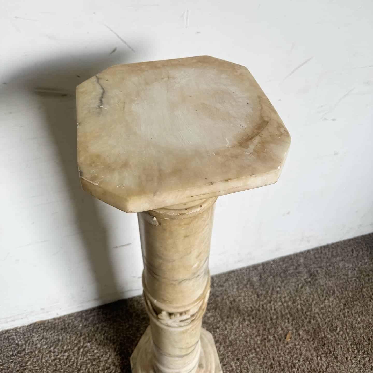 This Antique Alabaster Marble Pedestal exudes classical elegance and timeless charm. Perfect for displaying sculptures, plants, or decorative items, it features exquisite marble veining and intricate carvings. Ideal for entryways, living rooms, or