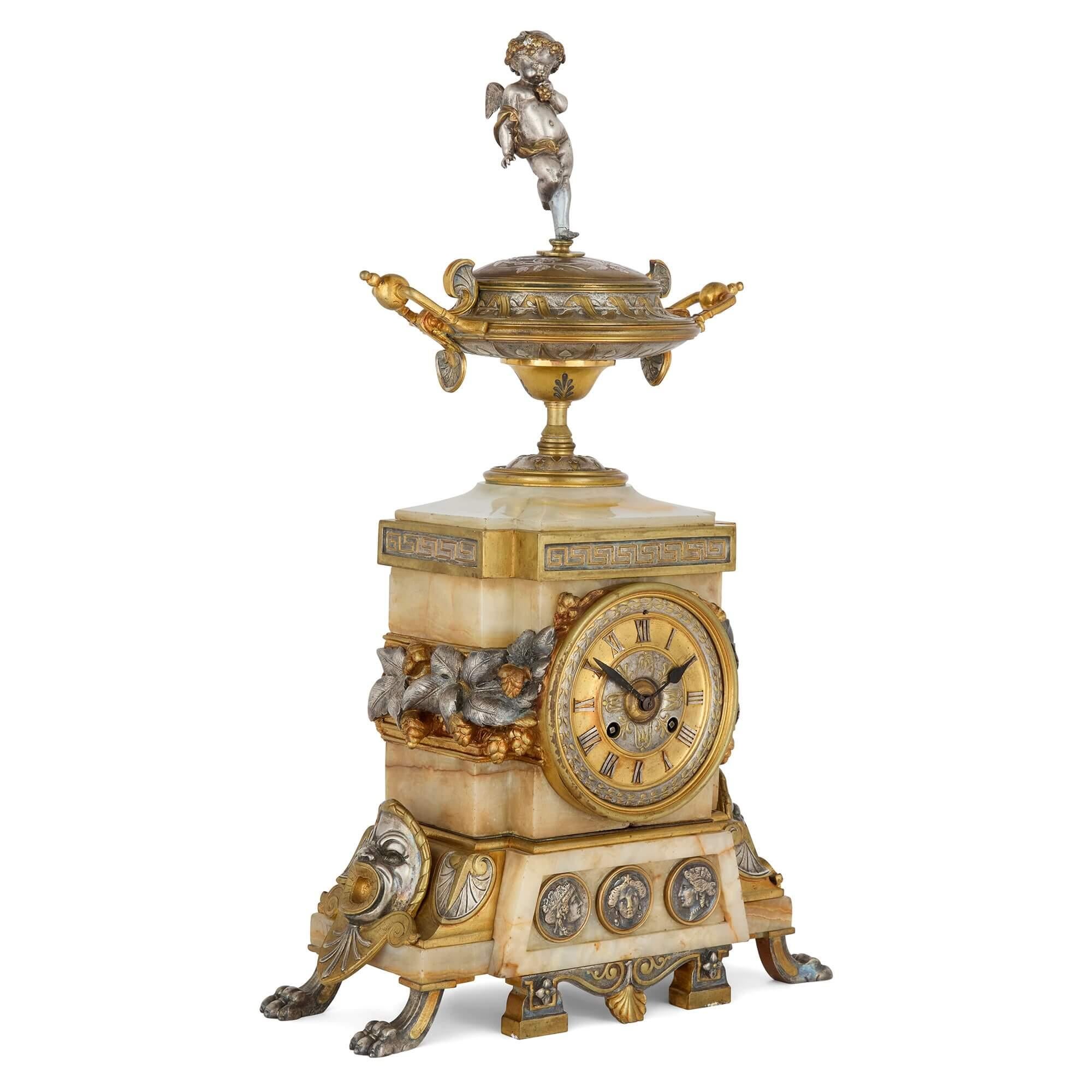 Antique Alabaster, Ormolu and Silvered Bronze Clock Set in the Neo-Grec Style
French, Late 19th Century 
Clock: Height 55cm, width 33cm, depth 16cm
Candelabra: Height 62.5cm, width 19cm, depth 19cm

This unusual clock set combines pale alabaster