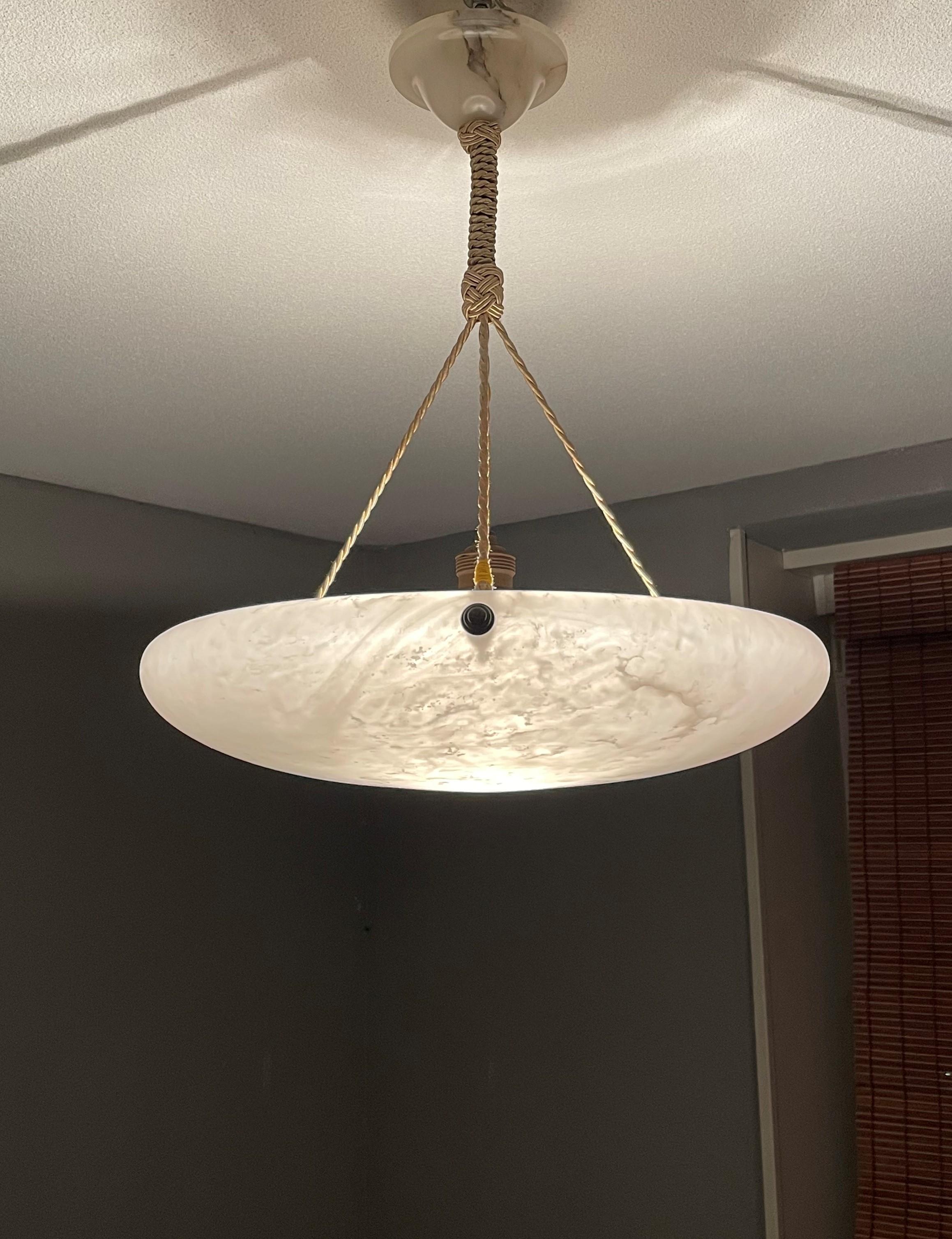 Timeless and beautiful design pendant with the perfect, pearl color alabaster shade.

With early 20th century light fixtures as one of our specialities, we have learned that certain shapes are more sought after than others. This relatively flat