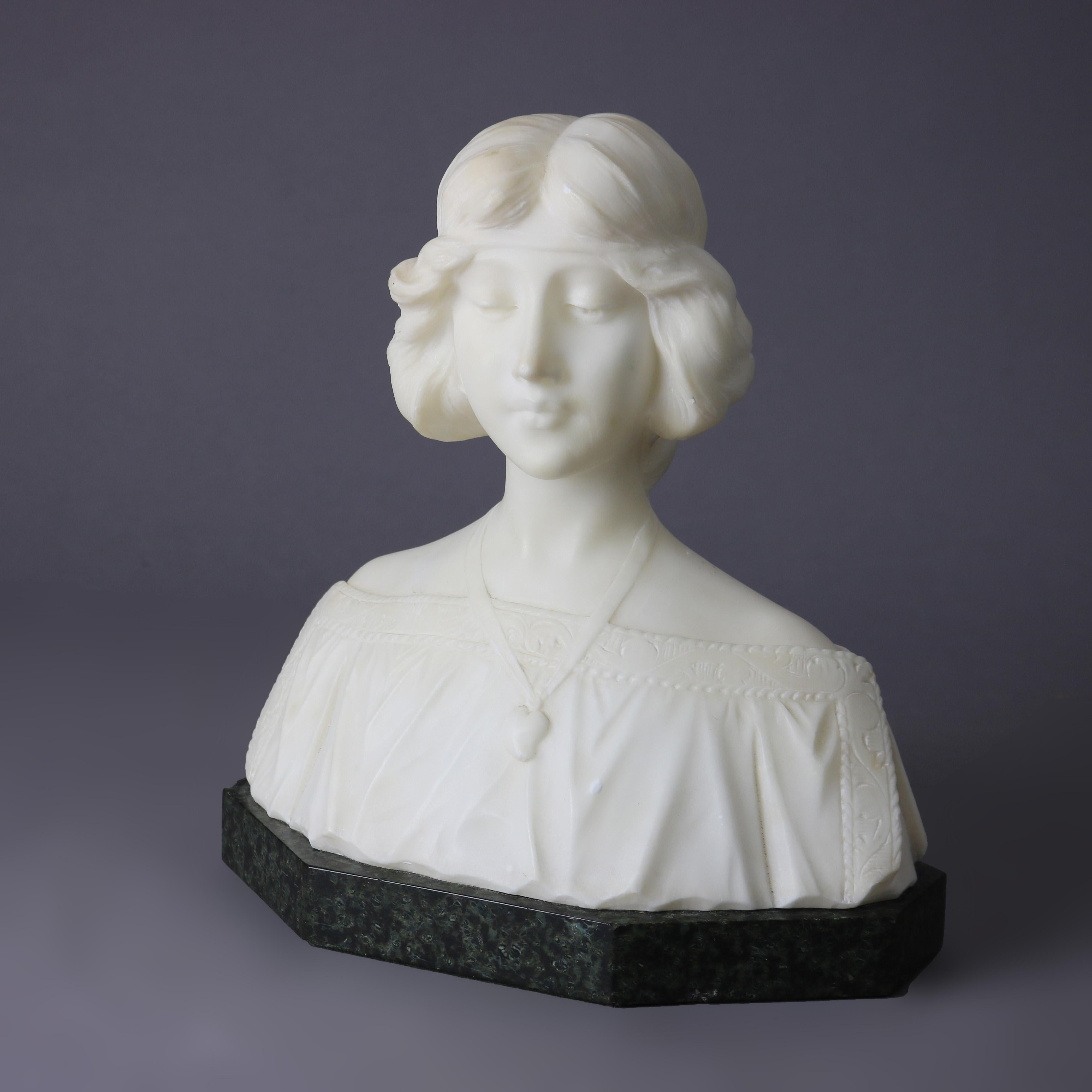 A carved alabaster sculpture depicts bust of a woman, seated on black marble base, circa 1890.

Measures - 11.75H x 10.75