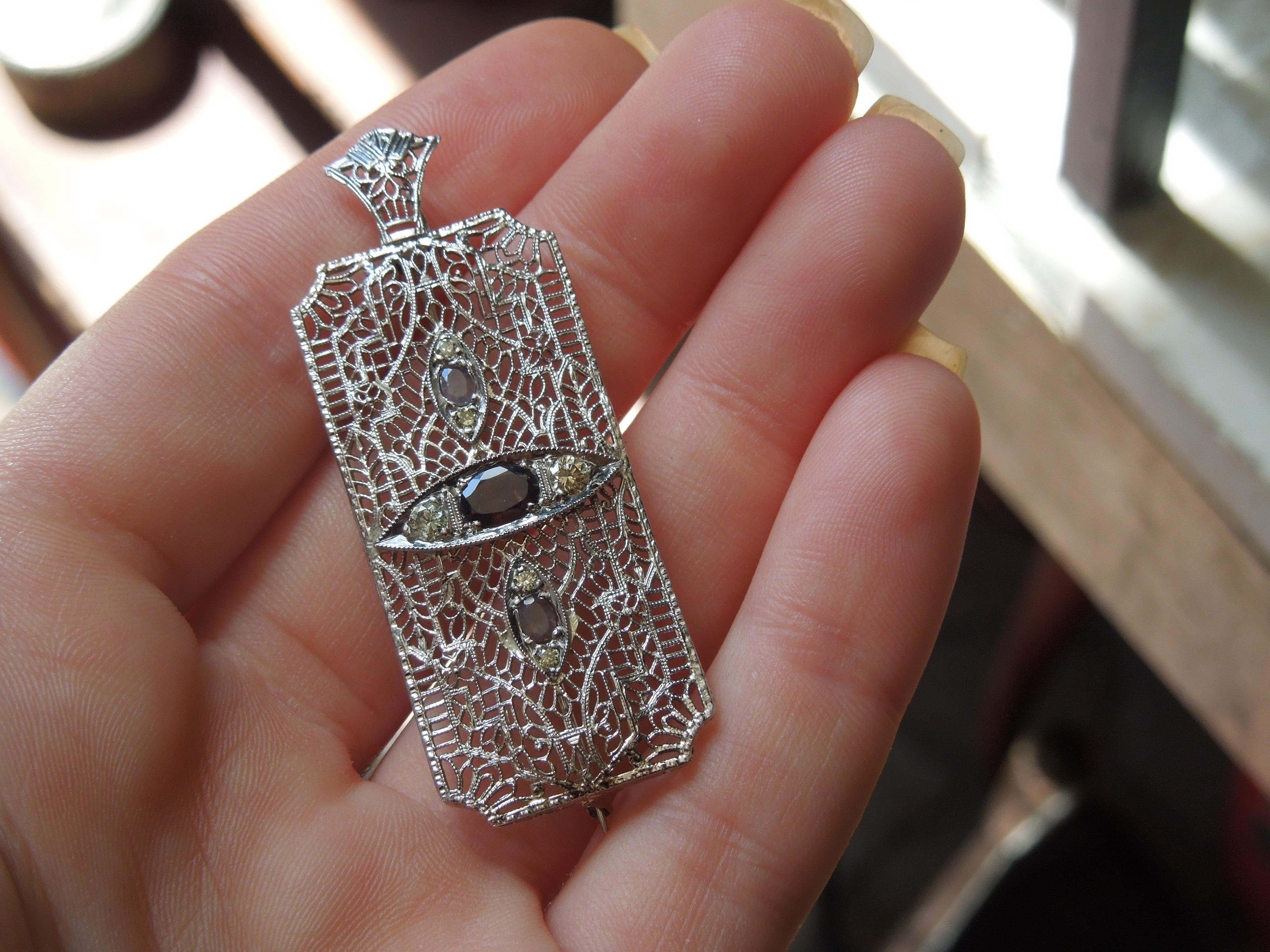 Antique Circa 1910

Constructed completely of 14 Karat White Gold with intricate Filigree work throughout, as well as a Bale added at a later time.
To be worn as a Pendant, or a Pin/Brooch if desired.

Containing 3 Genuine Earth-Mined Oval cut
