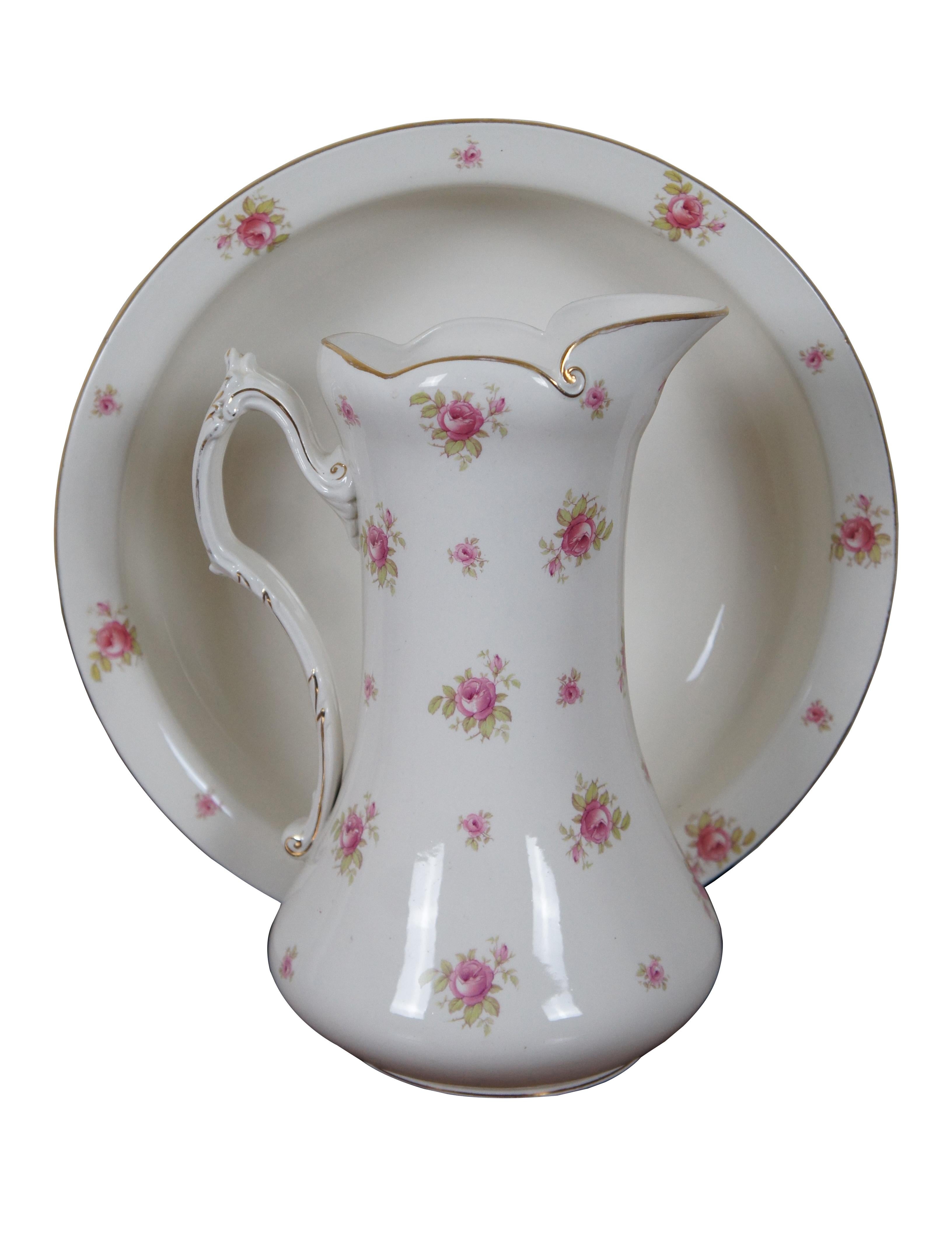 Antique English porcelain pitcher / ewer and wash basin / bowl set from Alfred B. Pearce & Company featuring printed pink roses and gilded accents. 

Alfred B. Pearce was a porcelain and glassware retailer that was established at Ludgate Hill,