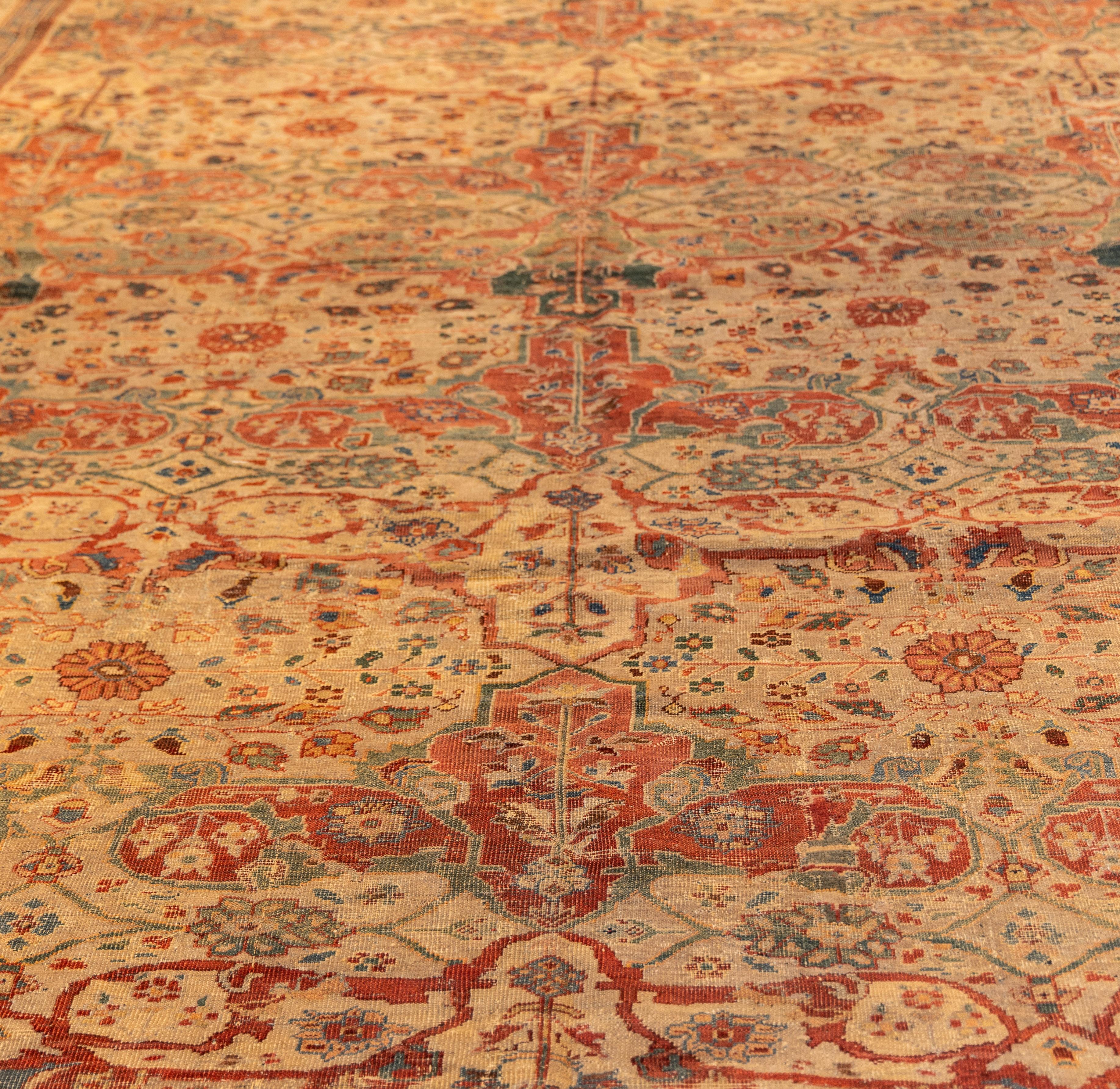 Featuring a repeating allover lattice formed by elegant palmettes connected by angular vinery and rosettes. The design is arranged in vertical rows, with the palmettes alternating in tone from terracotta to sage green and deep indigo,. The
