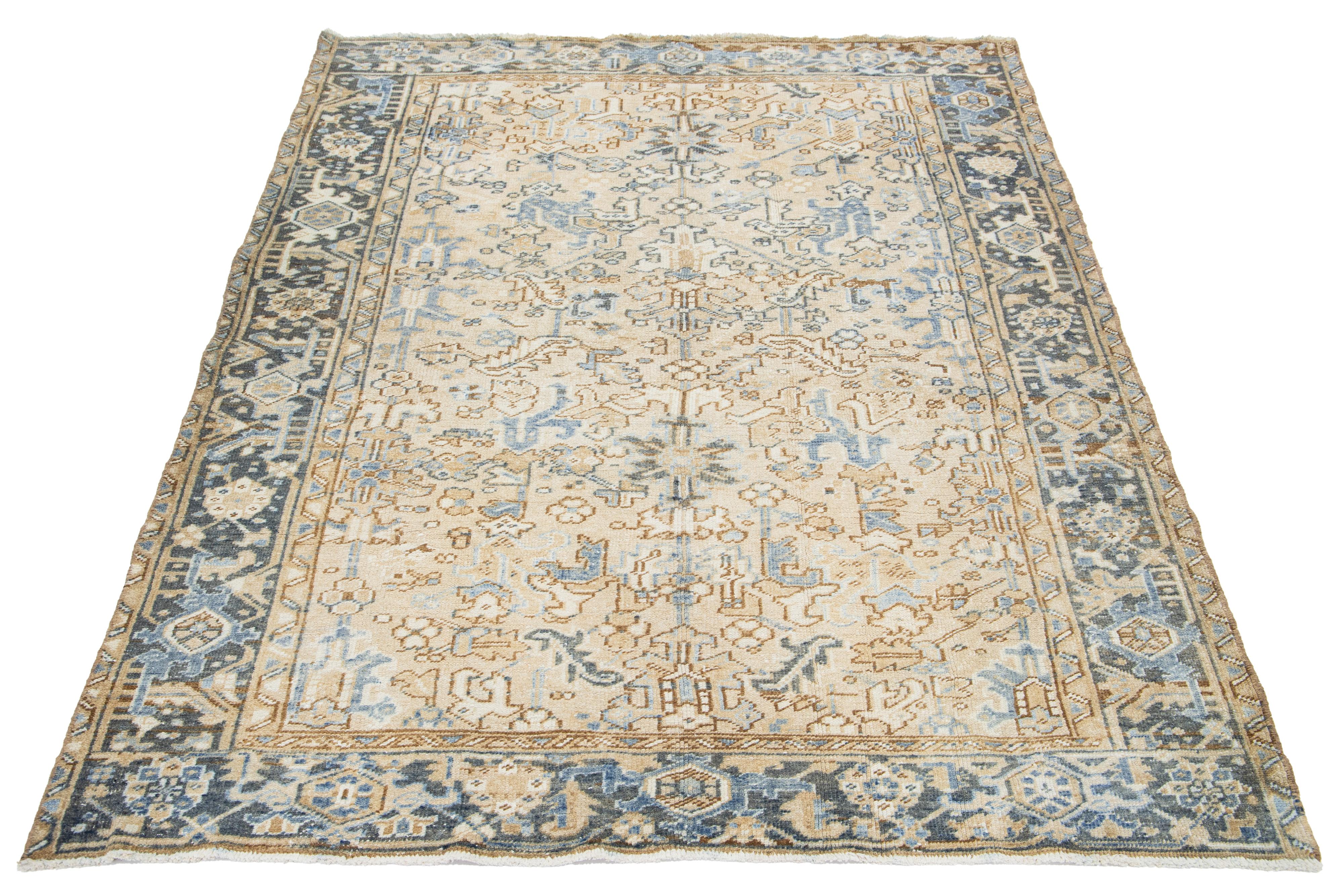 An antique Persian Heriz wool rug features a blue and brown pattern on a beige background.

This rug measures 5'10' x 8'2