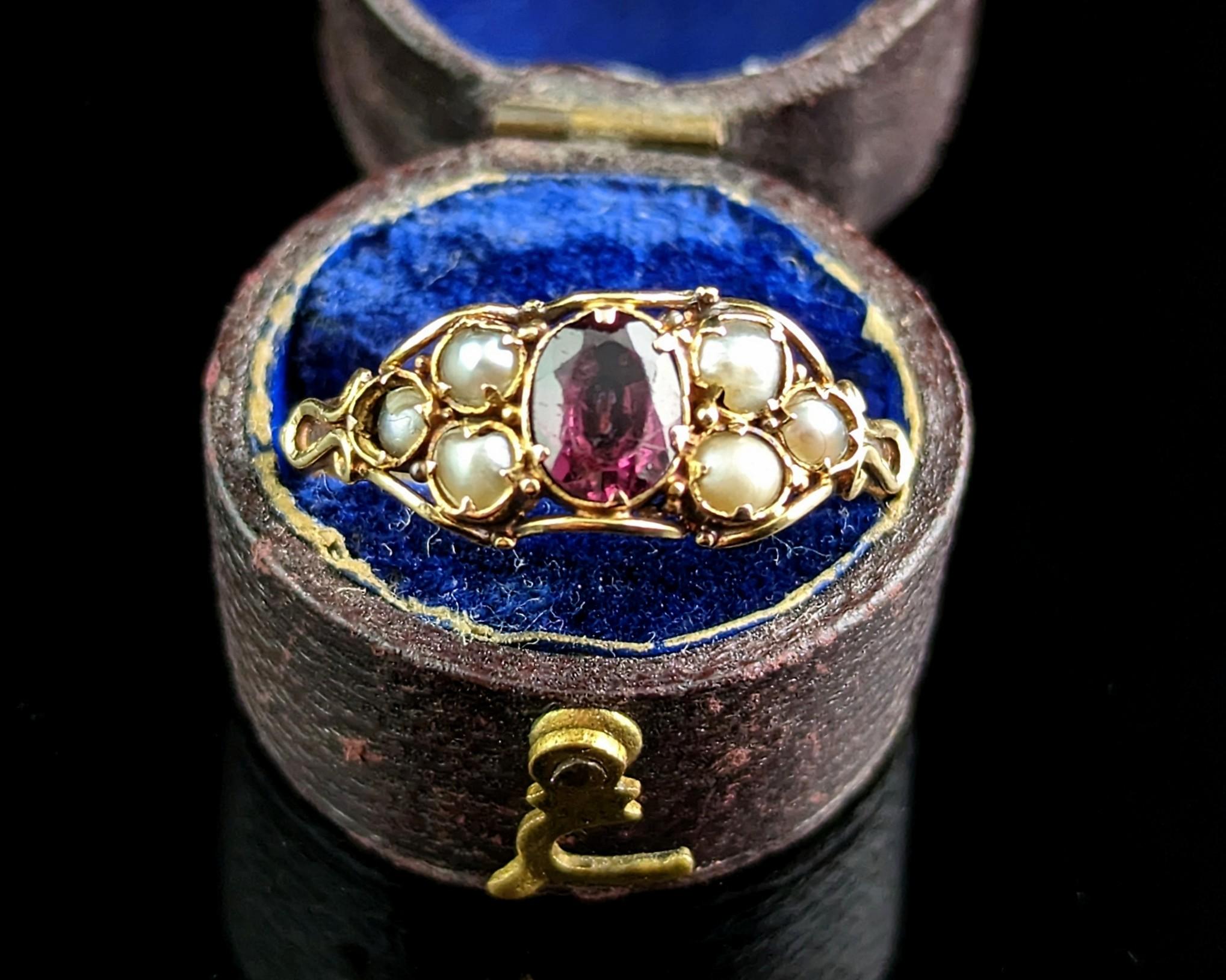 You will be charmed by this romantic antique, early Victorian Almandine garnet and pearl ring.

It features a lovely central Almandine garnet with rich red and purple tones to the side of the garnet there are three creamy seed pearls set in a