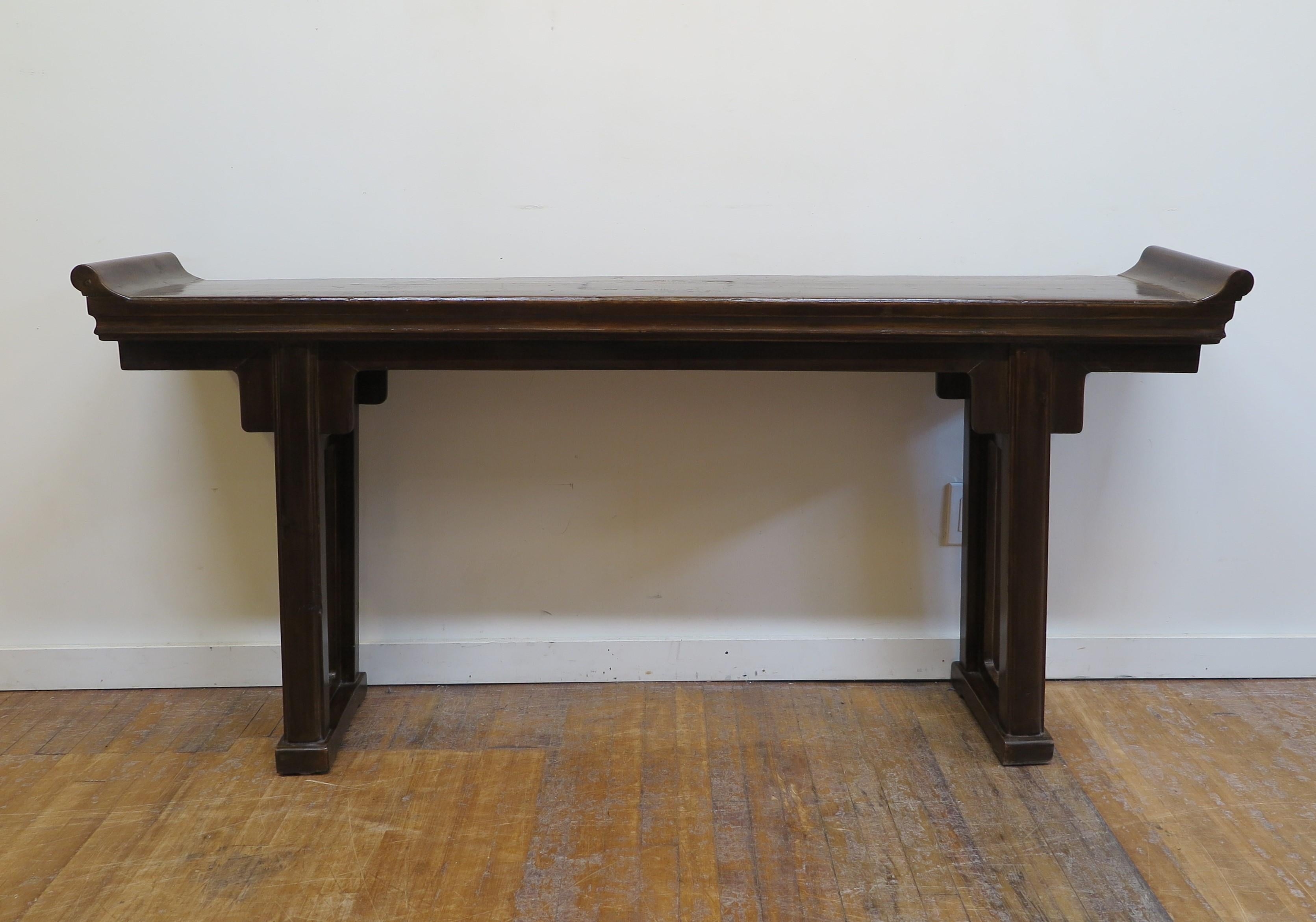 Chinese Antique Altar table console. Traditional Altar Table console of Elm wood with softly splayed legs one piece top having everted flanges attatched. Strong clean lines rooted in centuries of traditional style and craftsmanship. This altar table