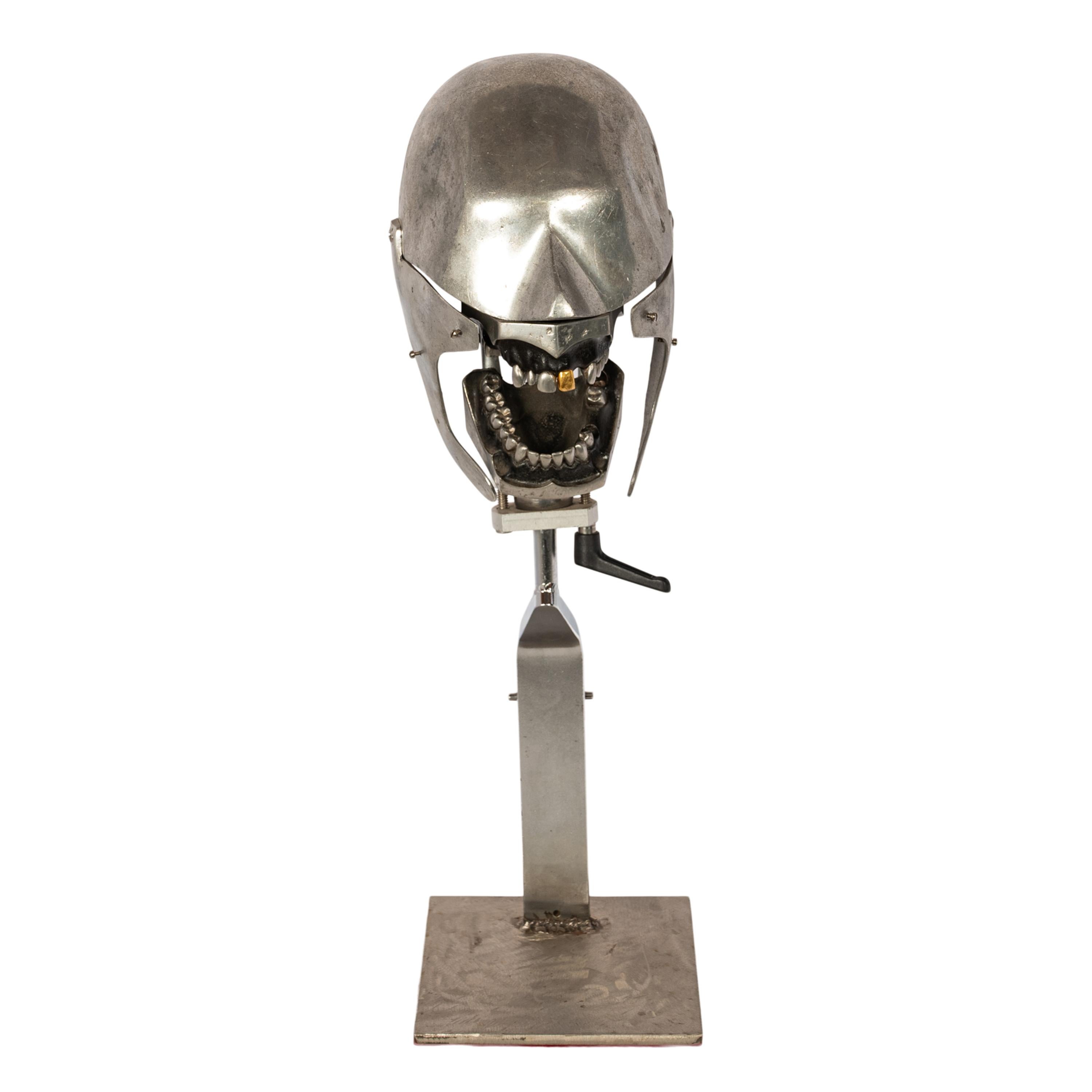 Antique aluminum dental phantom teaching head model with a gold tooth, 1920's.
A wonderful fun sculptural dental phantom, the aluminum head with lower and upper jaw one of the upper incisors is gold. The head can be posed with an adjustable lever