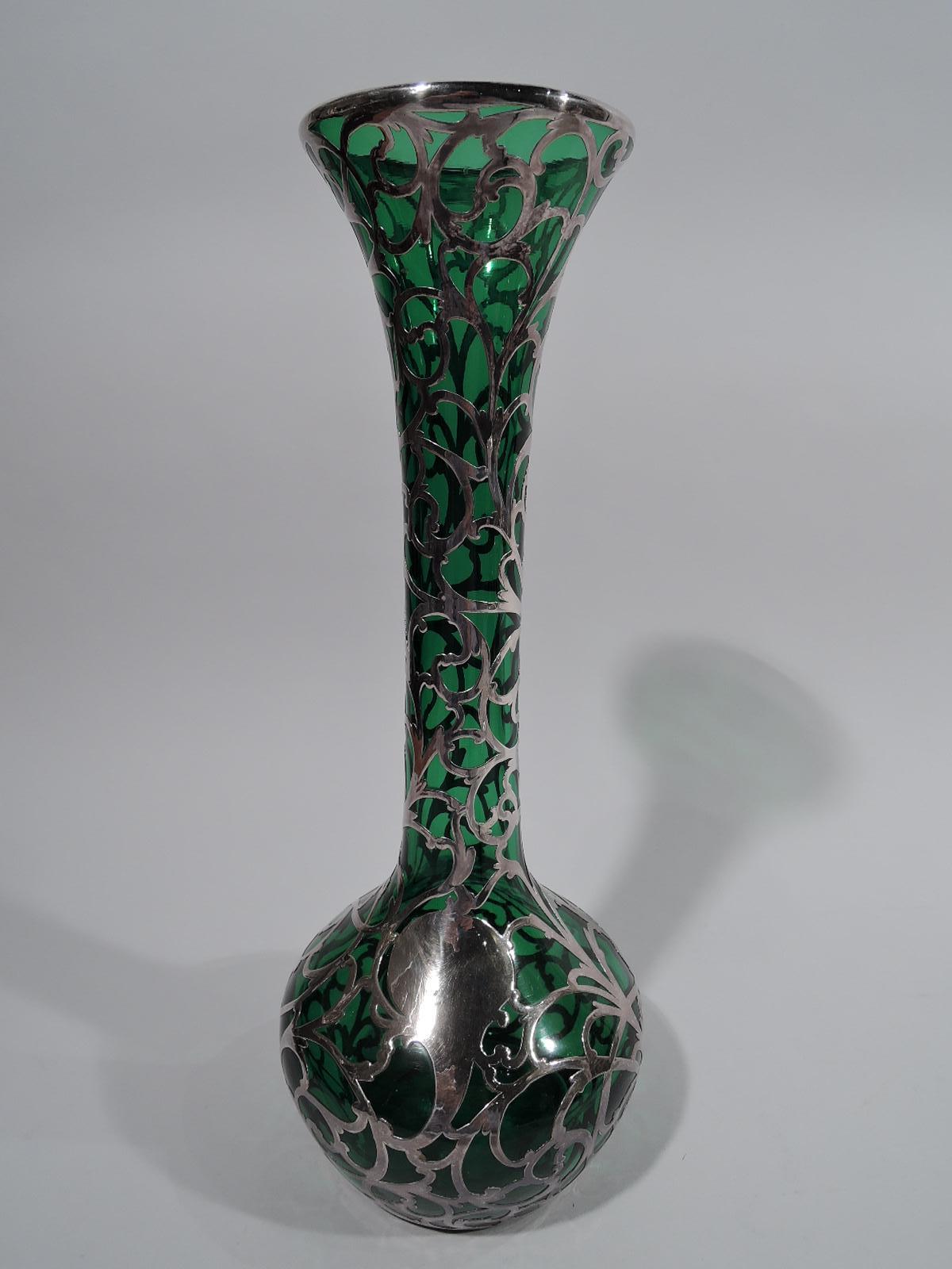 Turn-of-the-century Art Nouveau glass vase with silver overlay. Made by Alvin in Providence. Tall cylindrical neck with flared mouth; globular bowl. Scrolled overlay with asymmetrical cartouche (vacant). Glass is dark green. Faint marks including