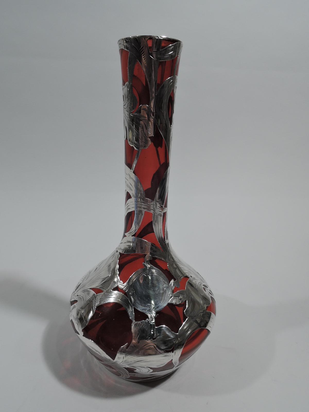 Turn-of-the-century Art Nouveau glass vase with engraved silver overlay. Made by Alvin in Providence. Bellied bowl and cylindrical neck with flat mouth. Bold and dynamic Overlay in form of iris flowers with entwined and scrolling tendrils. Glass is