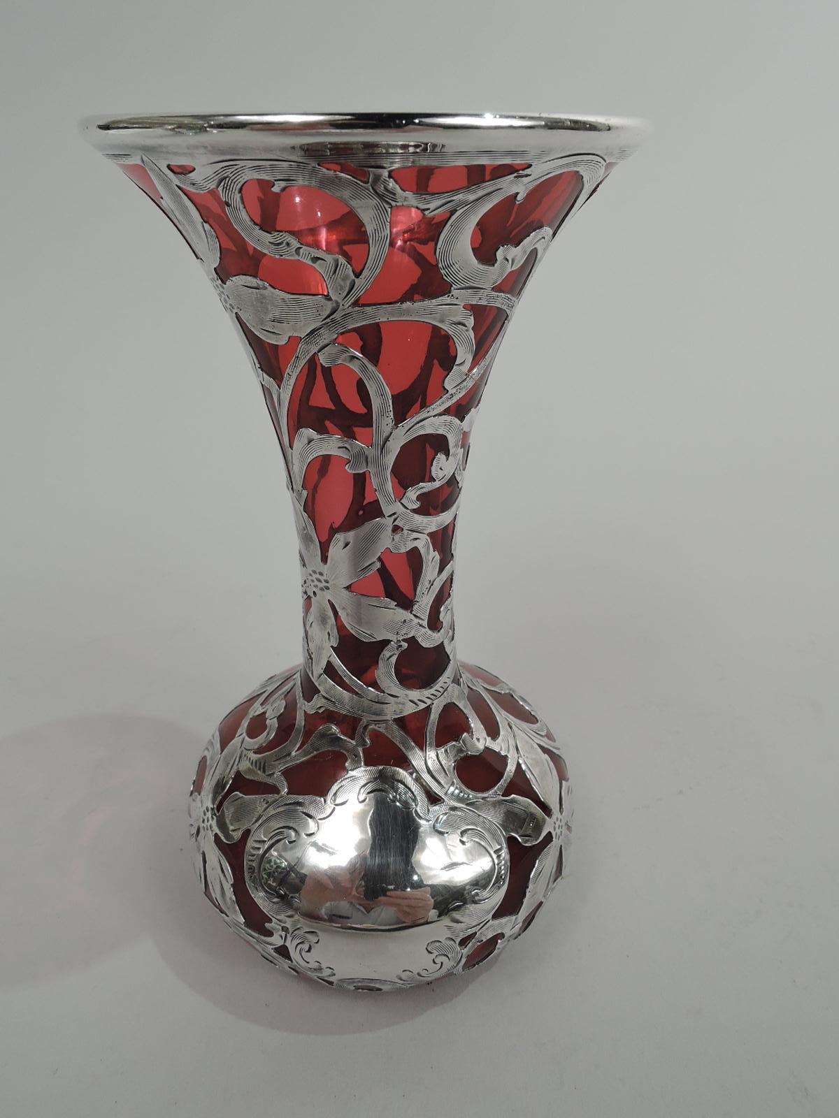 Turn-of-the-century Art Nouveau glass vase with engraved silver overlay. Made by Alvin Corporation in Providence. Conical mouth and neck and bellied bowl. Overlay in form of scrolled tendrils and flower heads, and scroll shaped cartouche (vacant).