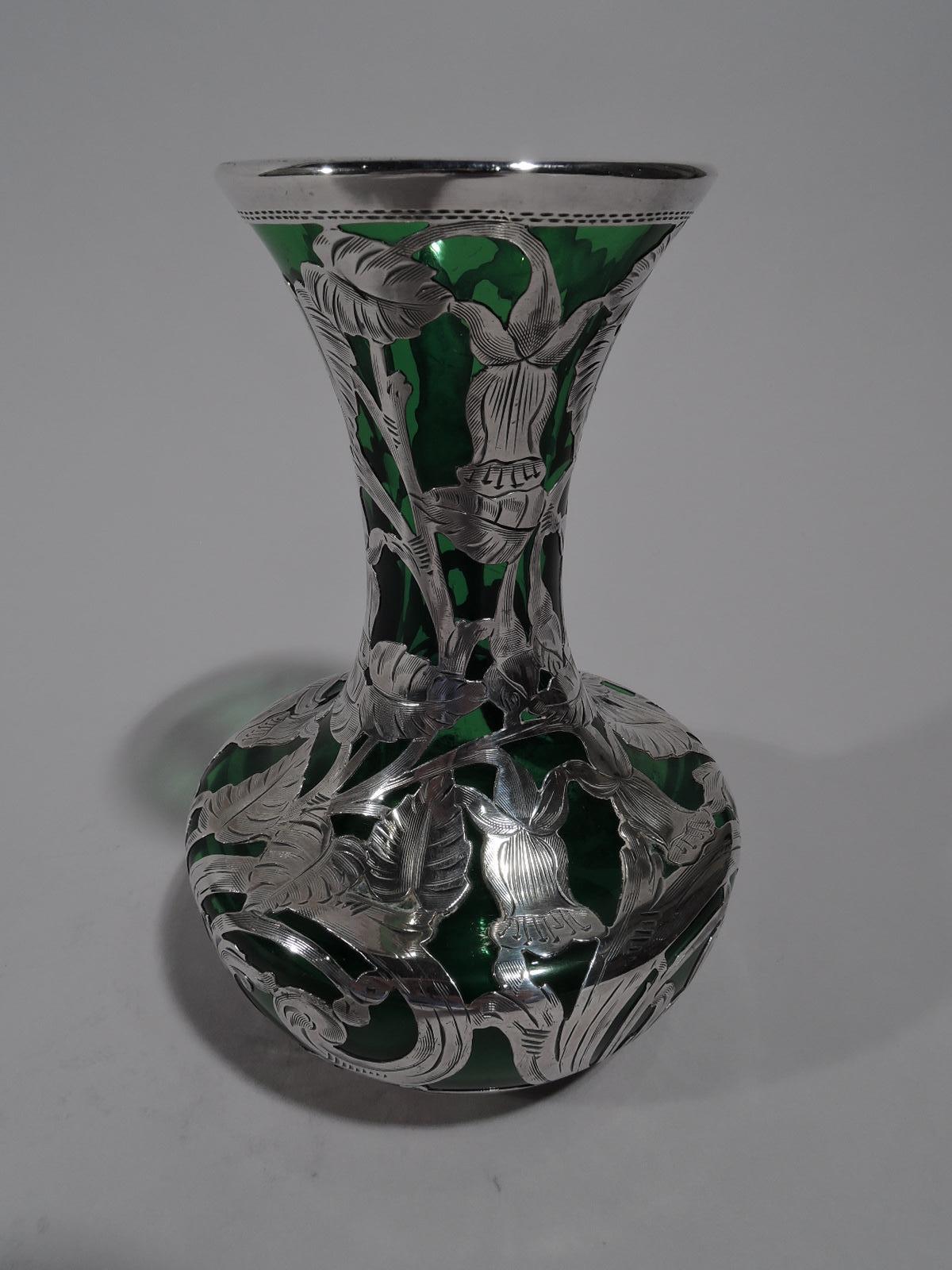 Turn of the century Art Nouveau green glass vase with silver overlay. Made by Alvin in Providence. Bellied bowl with flared cylindrical neck. Flowers, leaves, and scrolls in dense overlay heightened with engraving. Fully marked and numbered G3452.