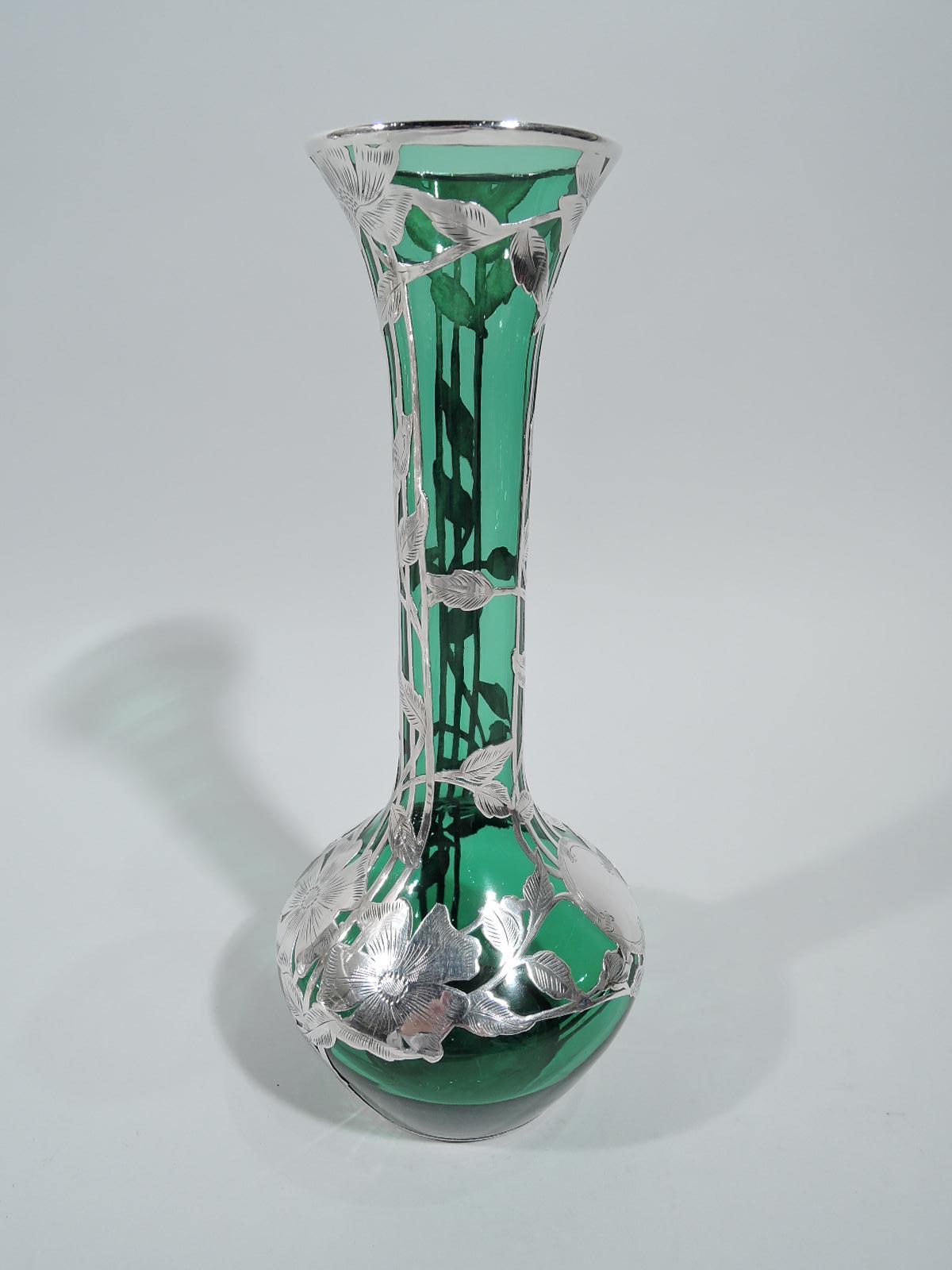 Turn of the century Art Nouveau glass vase with engraved silver overlay. Made by Alvin in Providence. Tapering bowl, cylindrical neck, and flared mouth. Groups of vertical trellis lines entwined with stem flowers. Bowl shoulder has flower-head