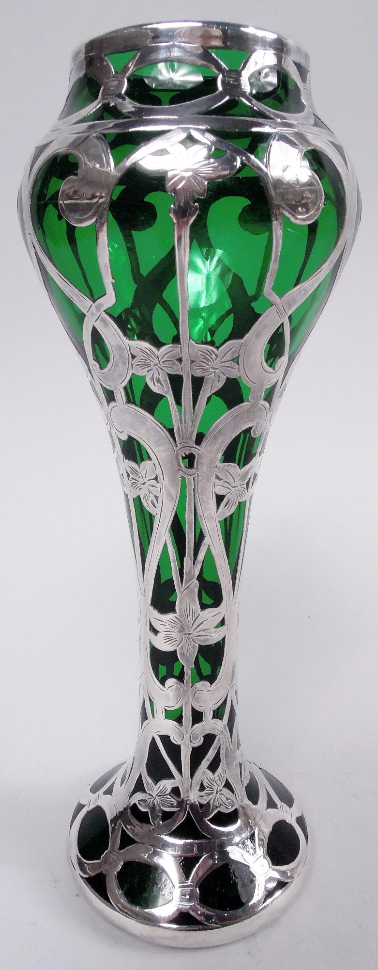 Art Nouveau glass vase with engraved silver overlay. Made by Alvin Corp. in Providence, ca 1900. Baluster bowl on narrow cylindrical support flowing into raised foot. Vertical overlay pattern in form of elongated s-scrolls overlapping stem flowers.