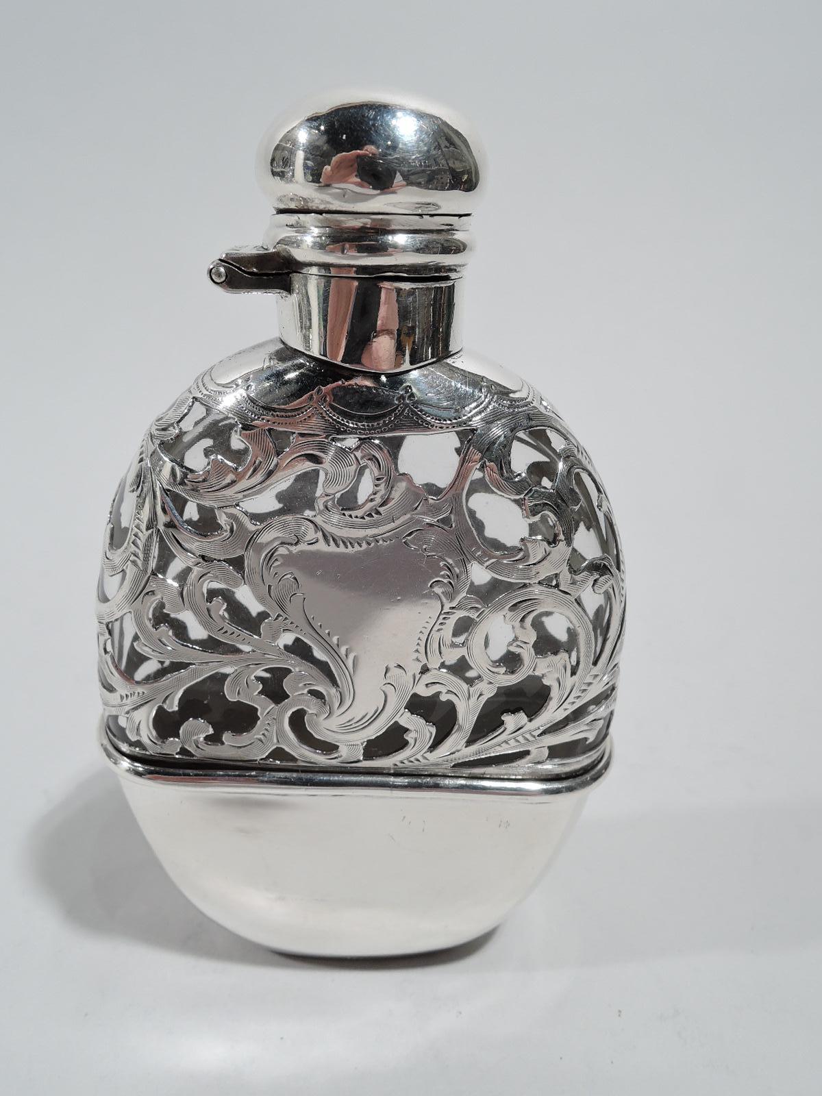 Turn-of-the-century Art Nouveau glass flask with engraved silver overlay. Made by Alvin in Providence. Ovoid body with curved sides and flat front and back. Sterling silver neck collar and hinged and cork-lined cover. Top half has silver overlay in