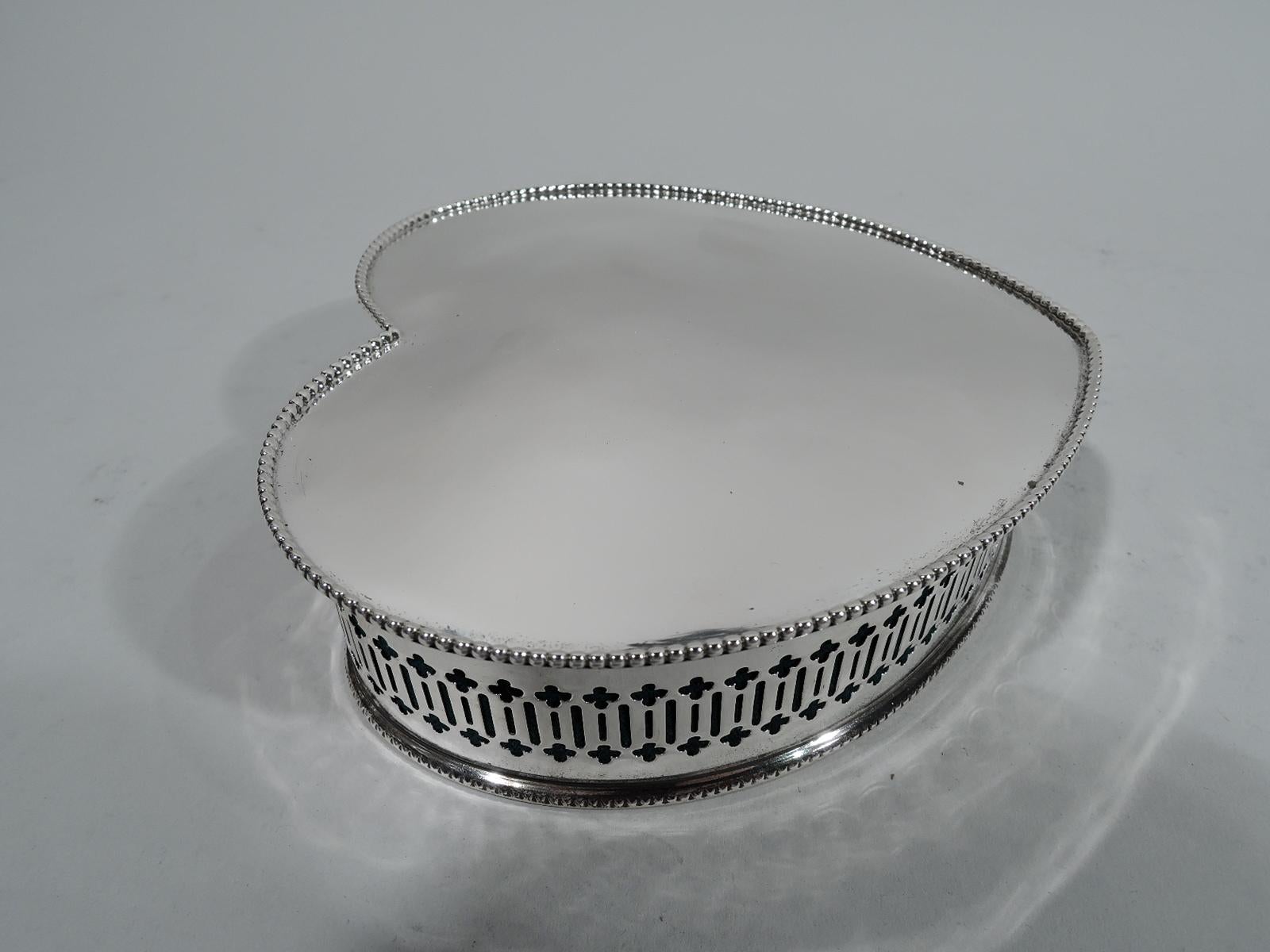 Edwardian sterling silver jewelry box. Made by Alvin in Providence, circa 1910. Heart-shaped. Sides have pierced quatrefoils and lines, and base dentil rim. Cover hinged and curved with beaded rim. Underside open. Velvet liner. Fully marked and