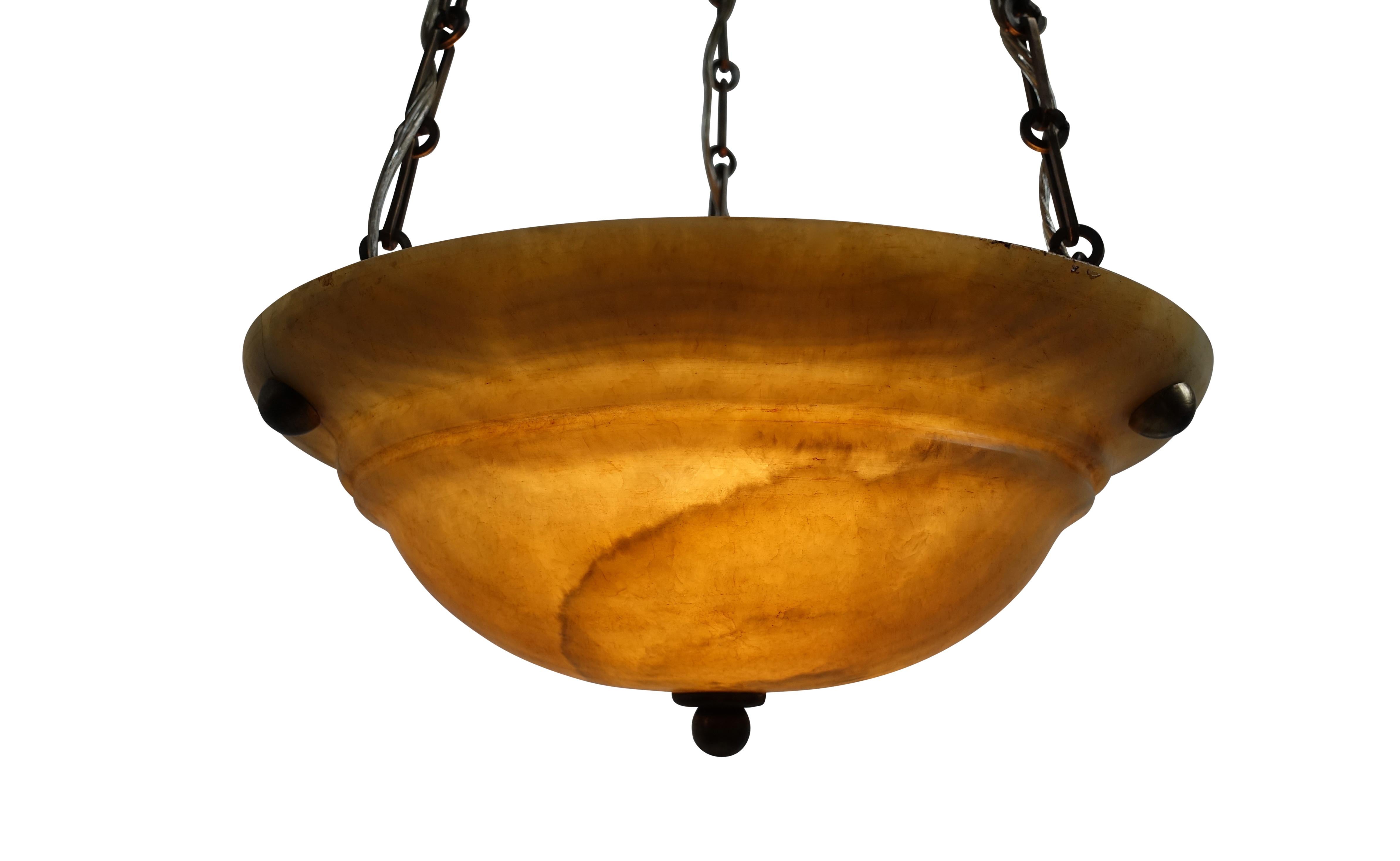 Small amber color alabaster bowl with nice quality chain and canopy. Recently reconditioned, and re-wired, holds three chandelier size light bulbs. Can be lengthened or shortened to desired measurement.