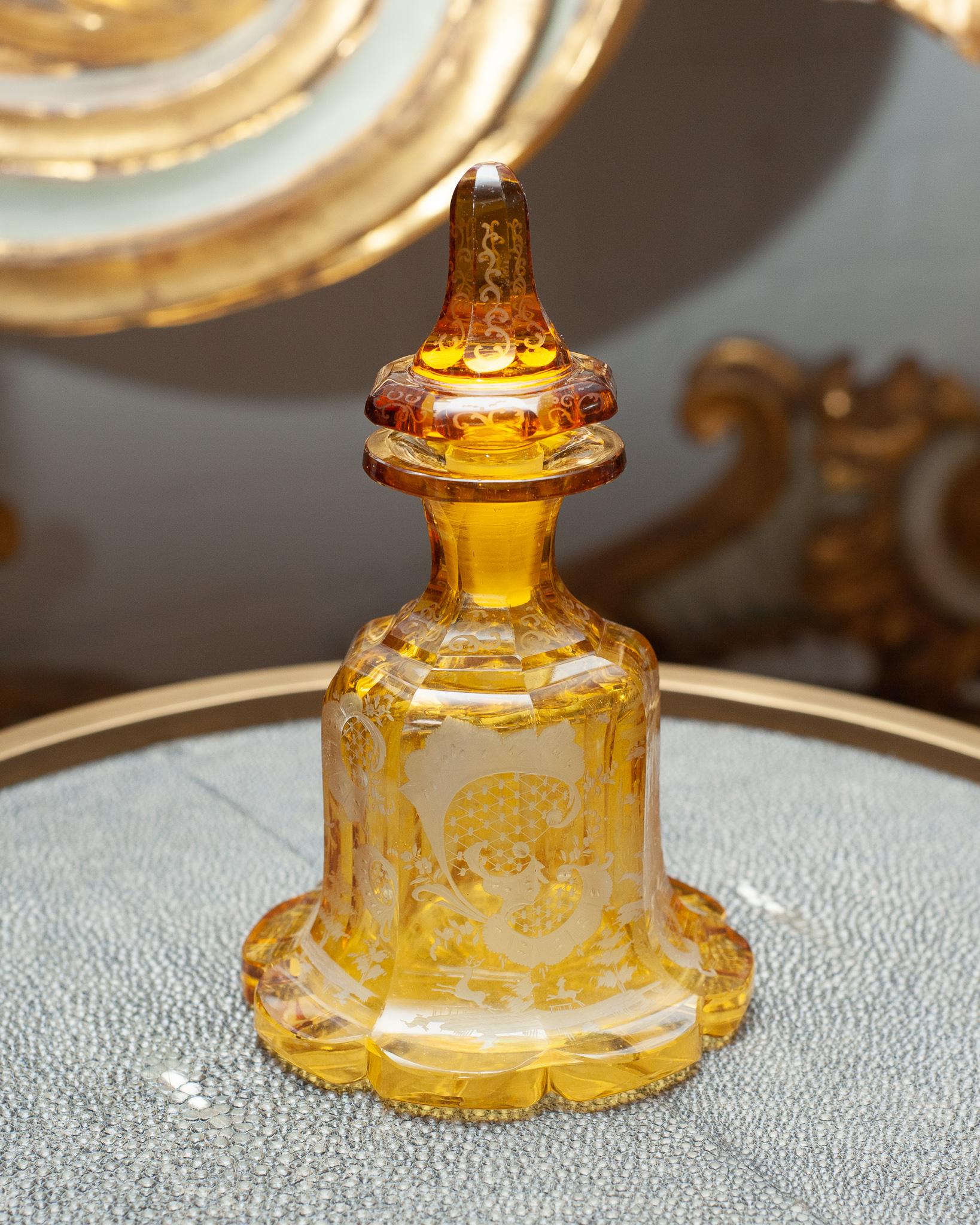 A large antique Bohemian amber glass perfume bottle with cut crystal ornate floral patterns. The artistry of the cut crystal makes this vessel so special and could be used on the table for holding olive oil or vinegar.