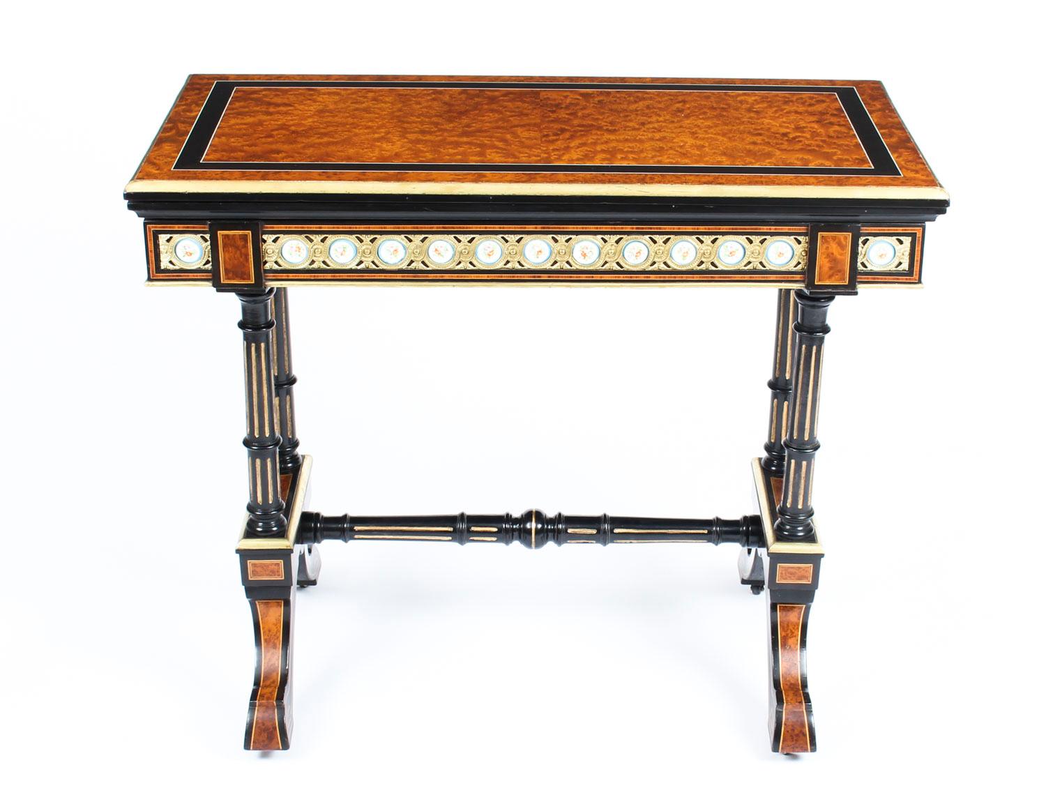 This is a magnificent antique French amboyna and ebonized card table fabulous Sevres style porcelain plaques set in decorative ormolu mounts, circa 1860 in date.

The table is made from striking and rare amboyna, and then beautifully decorated with