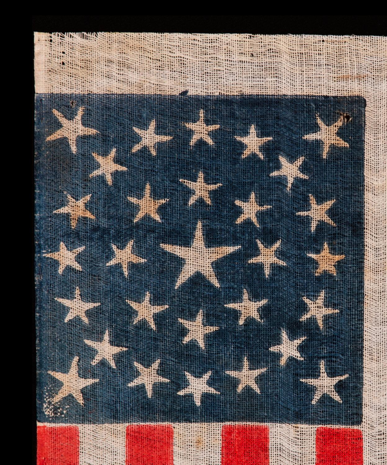 ANTIQUE AMERICAN FLAG WITH 29 WHIMSICAL STARS IN A MEDALLION CONFIGURATION, IOWA STATEHOOD, PRE-CIVIL WAR, 1846-1848

29 star American national parade flag, printed on coarse, glazed cotton. The stars are arranged in a double wreath pattern with a