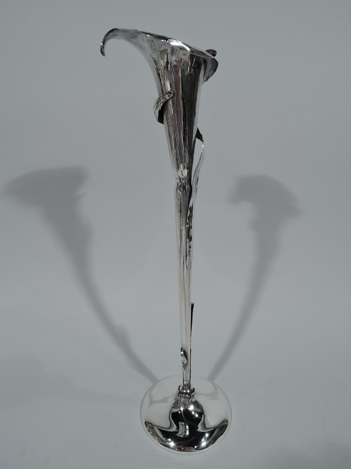 Aesthetic sterling silver vase. Made by Redlich in New York, circa 1900. Tall and narrow in form of calla lily with irregular petals and climbing, wrapping leaves. The stem appears to burst from “ground” of domed foot. A wonderful period piece that