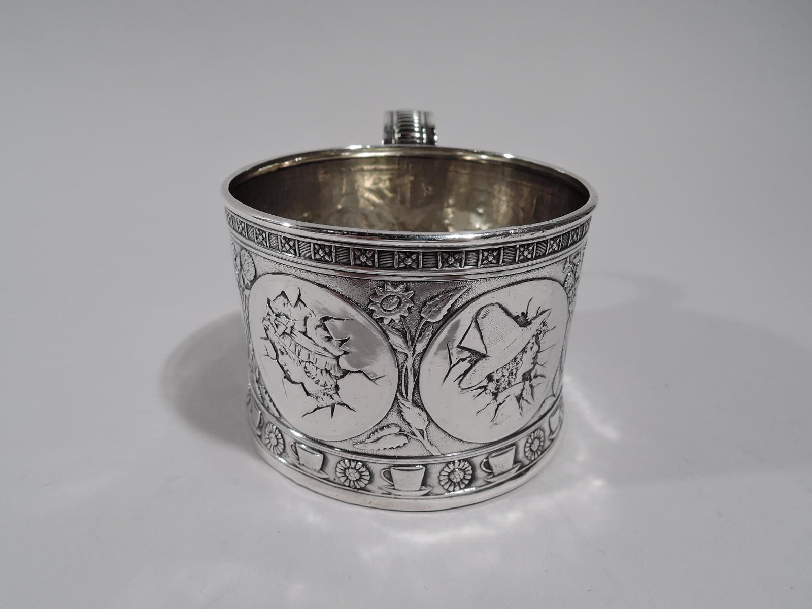 Ästhetische Babyschale aus Sterlingsilber. Hergestellt von Gorham in Providence im Jahr 1883. Rund mit geraden Seiten und verschnörkeltem und geripptem Griff. Ziseliertes Ornament in Form von Medaillons mit Kinderköpfen, die durch eine zerbrochene