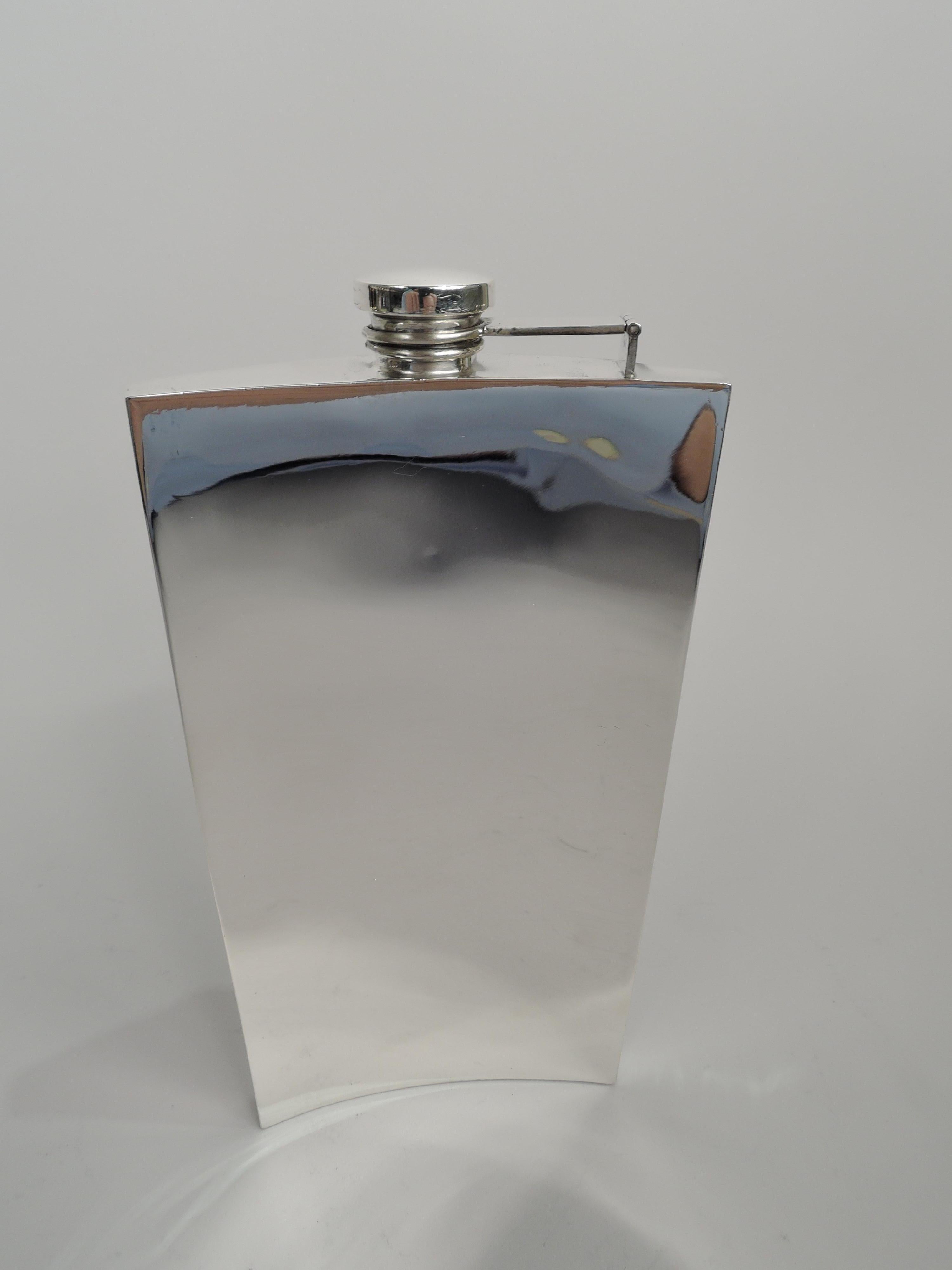 Art Deco sterling silver flask. Made by Watrous (part of International) in Wallingford, Conn., ca 1920. Curved and rectilinear with flat sides. Cover hinged, threaded, and cork-lined. On front are vertical engine-turned stripes with rectangular mono