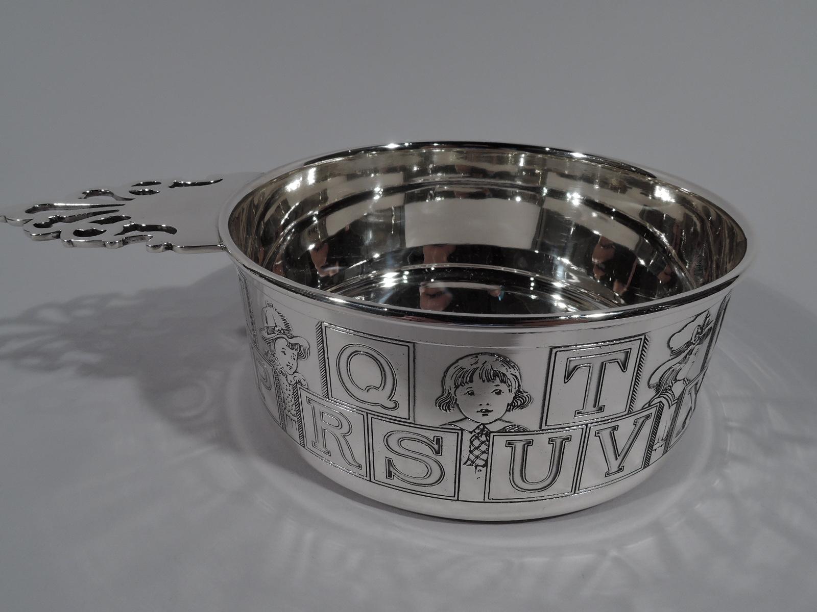 American Art Deco ABC sterling silver porringer. Straight sides and open-tree handle. Two rows of wraparound letter blocks with a medley of children’s heads from the old-fashioned miss to the bobbed Buster Brown kid to sober, neck-tied junior.