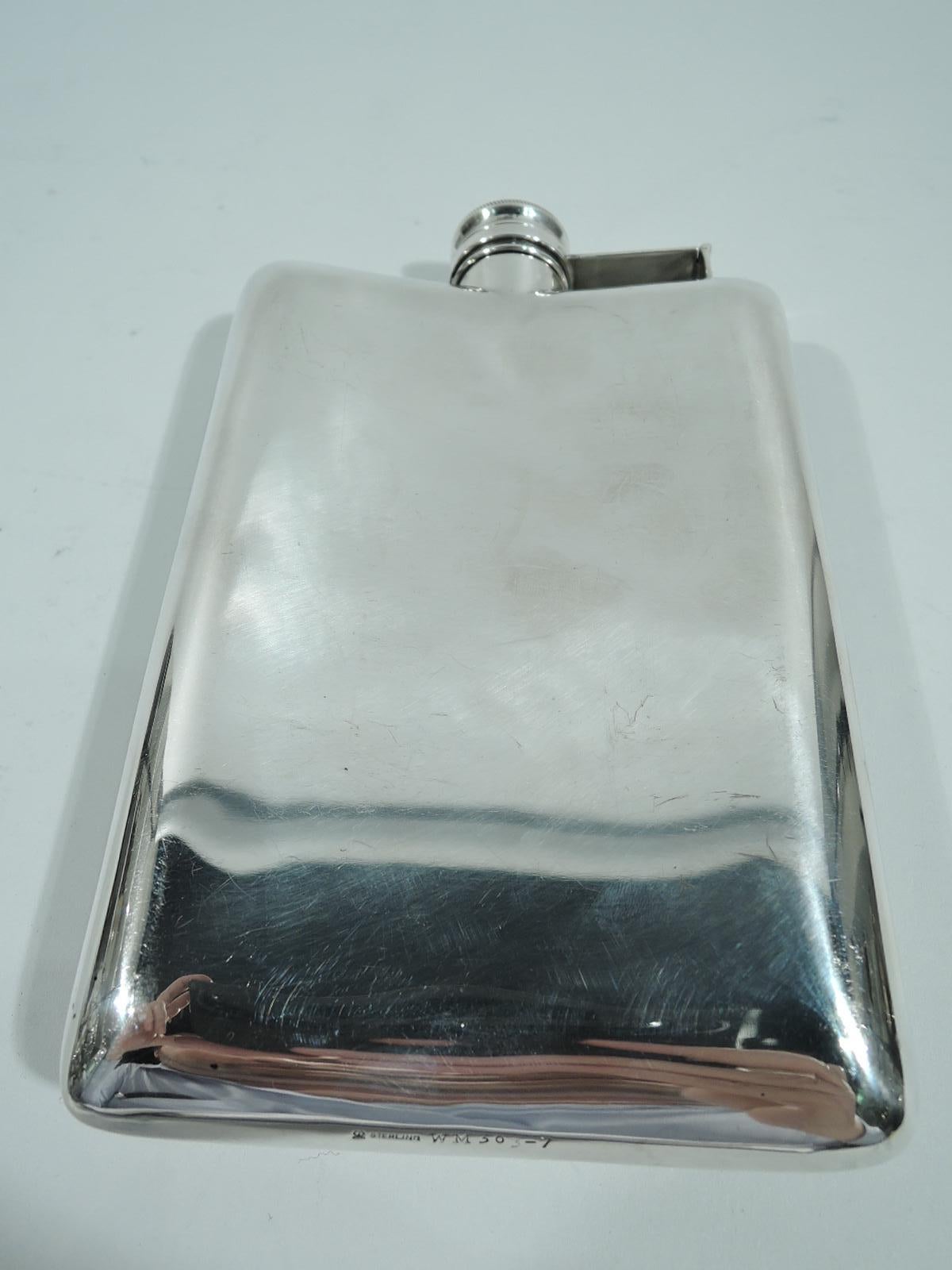 Art Deco sterling silver hip flask. Made by Meriden Britannia (part of International) in Connecticut, ca 1930. Rectilinear and concave with hinged and cork-lined cover. On front is incised vertical geometric pattern. Fully marked and numbered