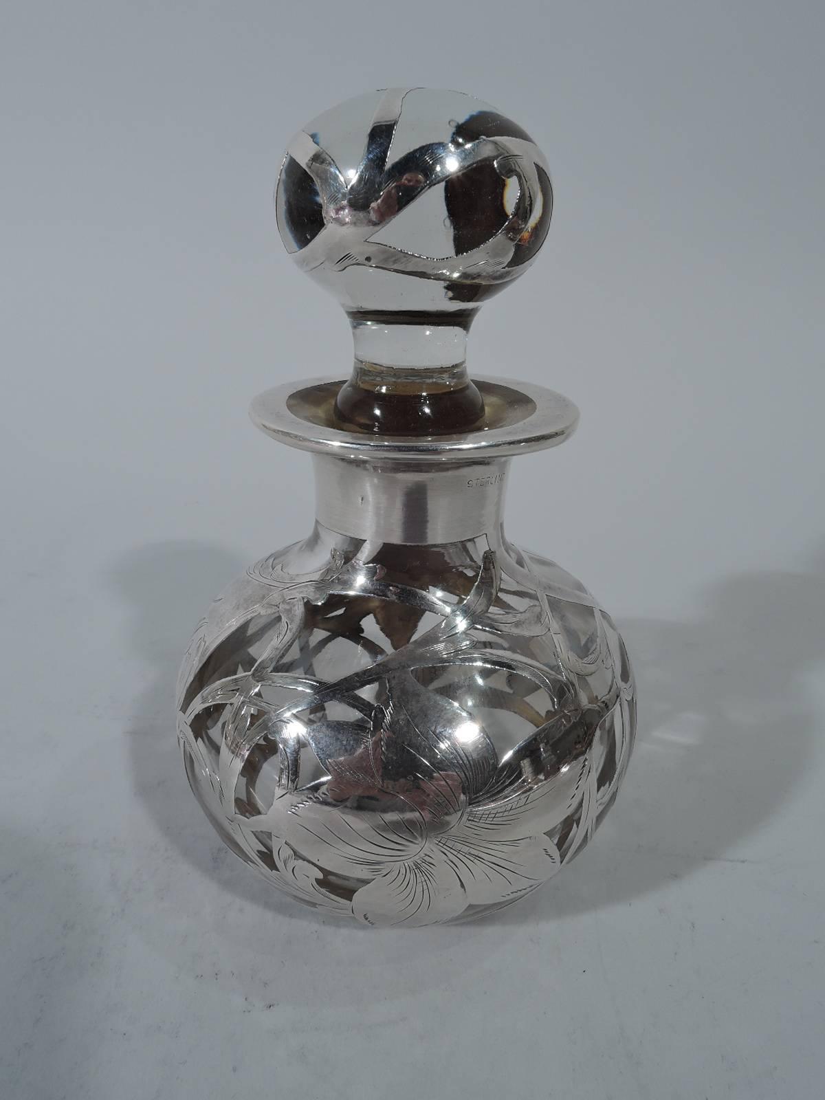 American Art Nouveau silver clear glass perfume bottle with silver overlay. Globular with short neck. Ball stopper with short plug. Silver overlay heightened with engraving: Loose and intertwining scrollwork and big blooms. Unmarked.