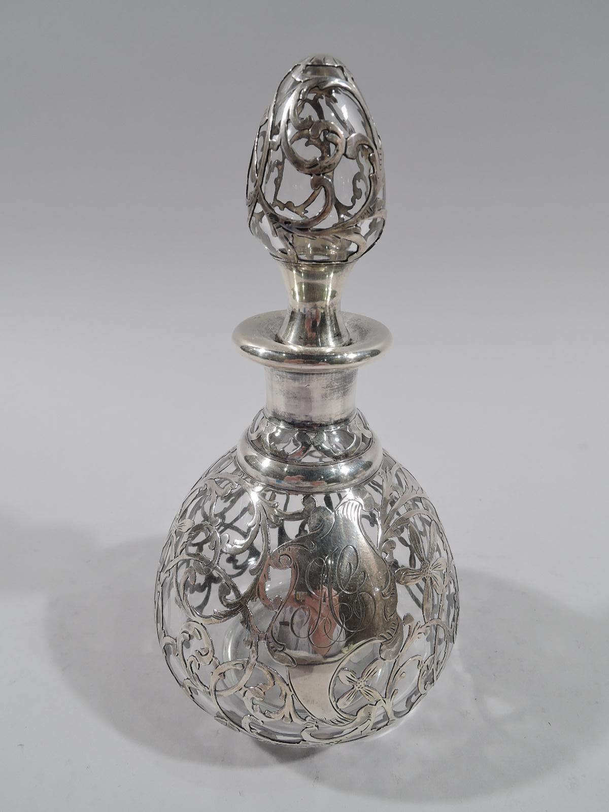 Turn-of-the-century American Art Nouveau glass perfume with engraved silver overlay. Ovoid bottle with short neck and everted rim in silver collar. Stopper ovoid with concave neck in same. Dense overlay in form of entwined and scrolling tendrils,