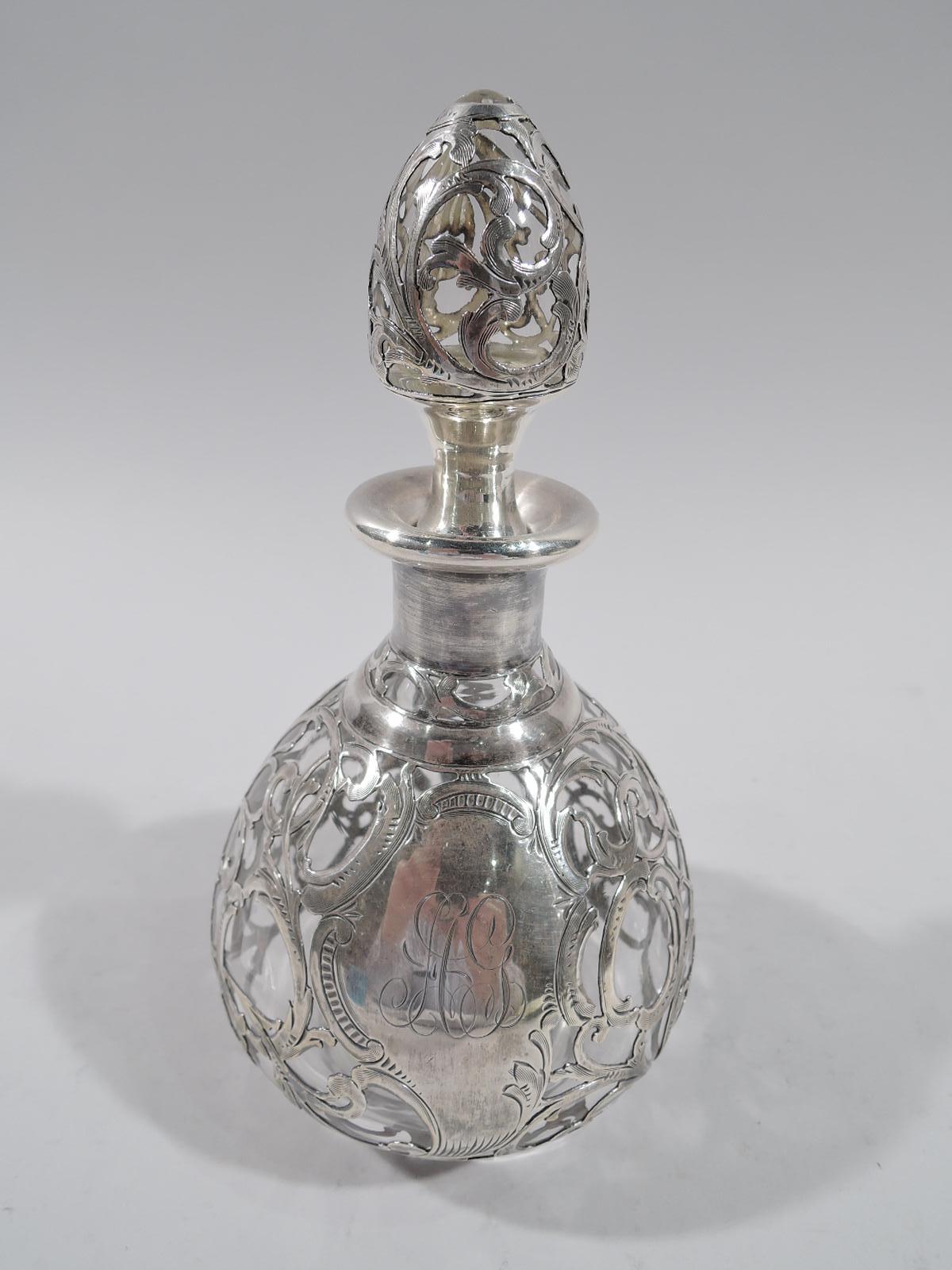 Turn-of-the-century American Art Nouveau glass perfume with engraved silver overlay. Ovoid bottle with short neck and everted rim in silver collar. Stopper ovoid with concave neck in same. Dense overlay in form of entwined and scrolling tendrils and
