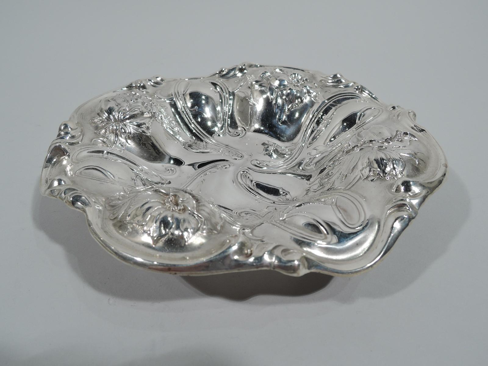 Turn-of-the-century Art Nouveau sterling silver bowl. Made by Woodside in New York. Round with shaped well and wavy scrolled rim. Sides lobed with chased flowers alternating with tendril frames flowing into well. Fully marked and numbered 2973.