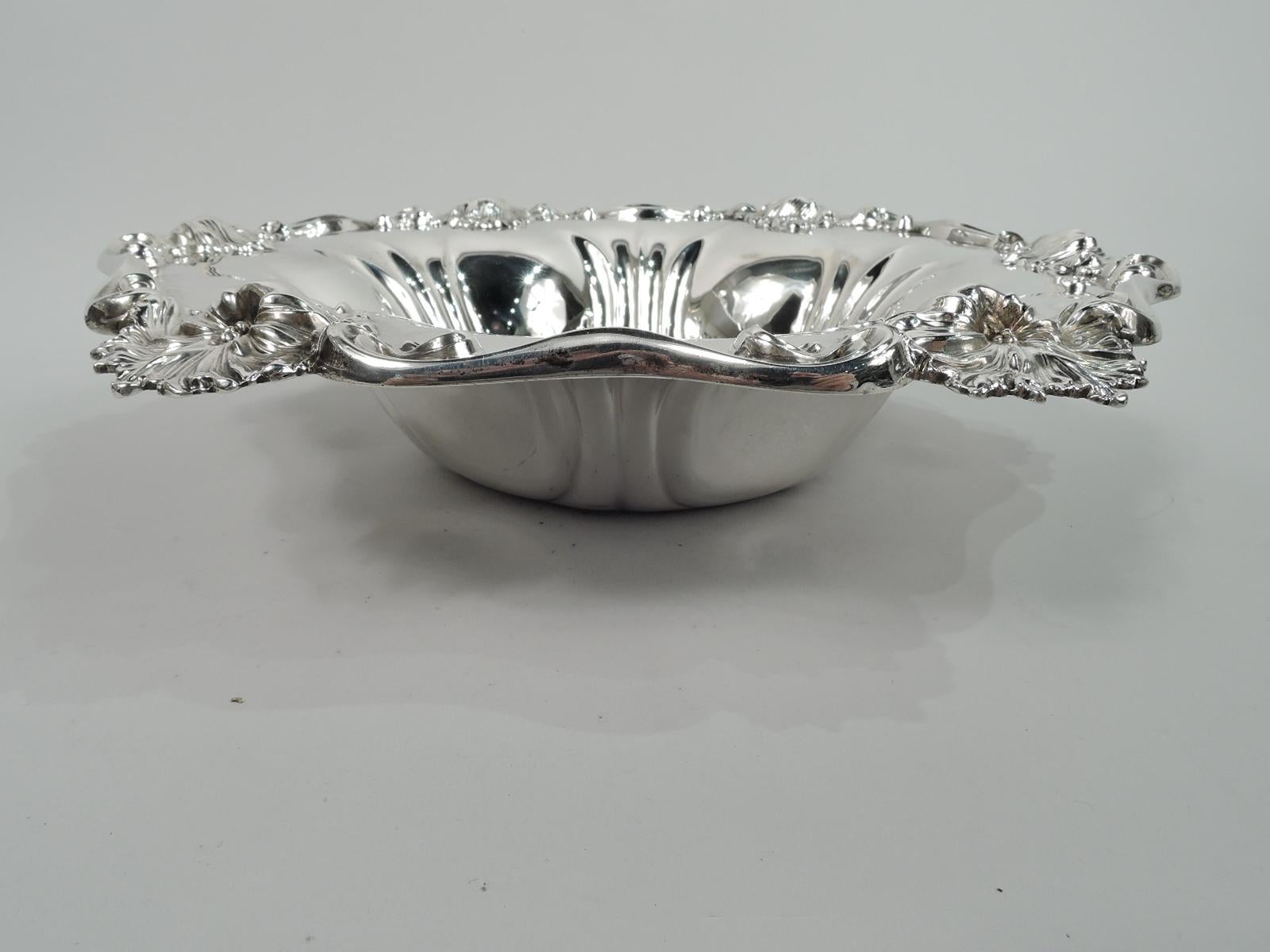Turn-of-the-century Art Nouveau sterling silver bowl. Made by Meriden Britannia (part of International) in Connecticut. Round well engraved with interlaced script monogram. Sides tapering and fluted. Scrolled rim with fluid and splayed flower heads.