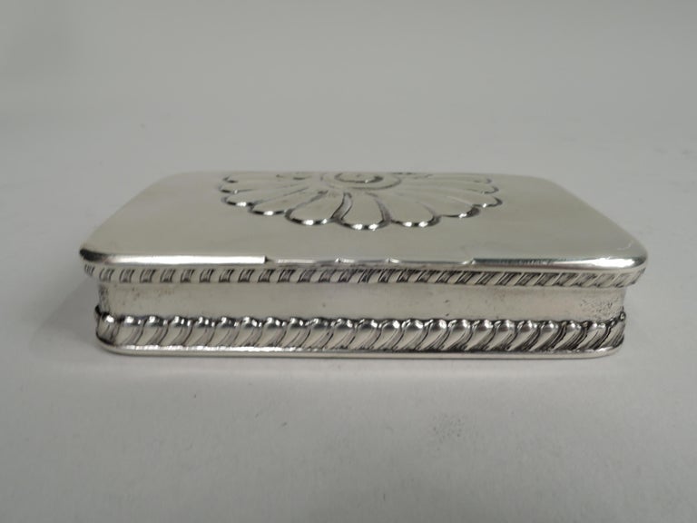 Art Nouveau sterling silver postage stamp box, 1892. Rectangular with straight sides and curved corners. Cover flat and hinged with large embossed scallop shell and scalloped tab. Applied wraparound gadrooned borders. Gilt-washed interior with