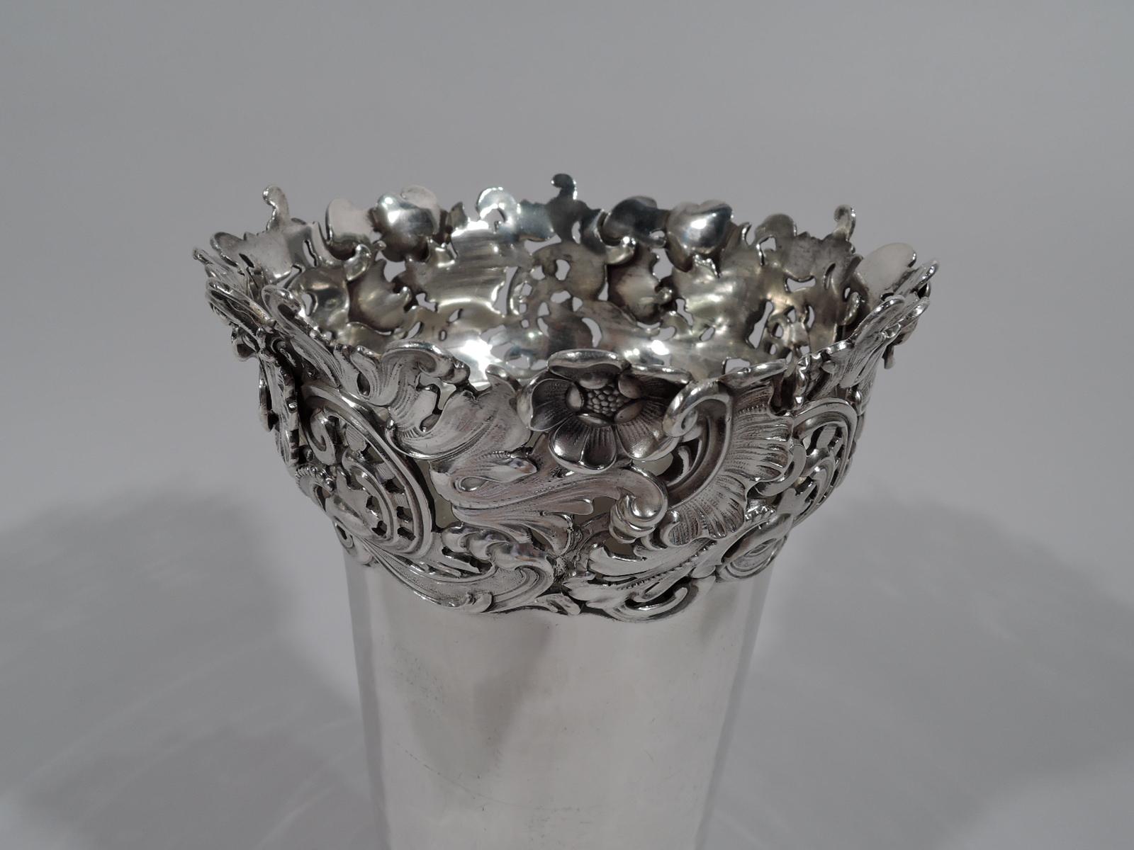 Art Nouveau sterling silver vase. Made by Redlich in New York, circa 1900. Plain cylinder with substantial leafy-scroll and flower mounts applied to base and rim. An unusual contrasting design. Fully marked and numbered 1682. Weight: 17 troy ounces.
