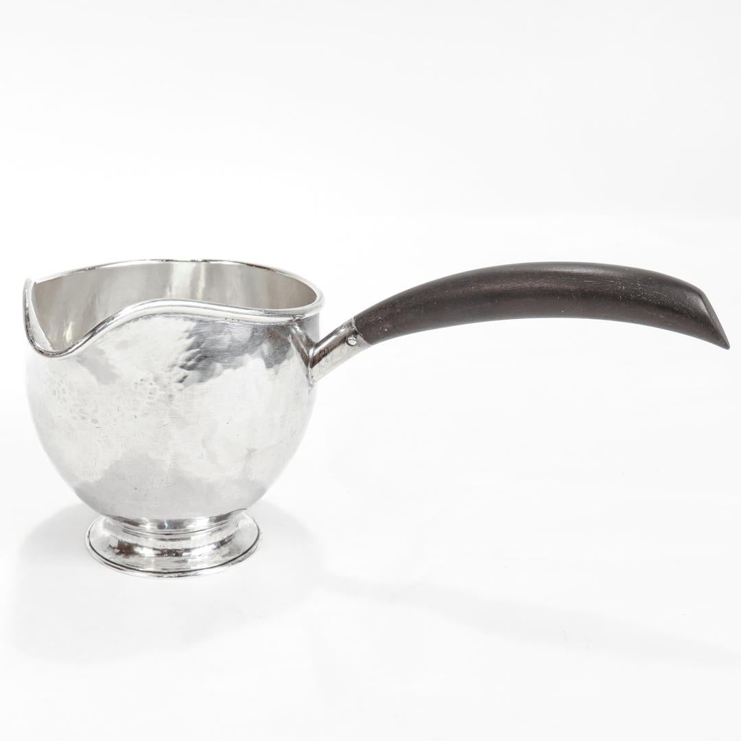 A fine antique brandy warmer

By the Kalo Shop in Chicago.

In hand-hammered sterling silver and mounted with an ebony wood handle.

Marked to the base Sterling / Handwrought at the Kalo Shop / SD1 / 1\4 Pints.

Simply a wonderful piece of American