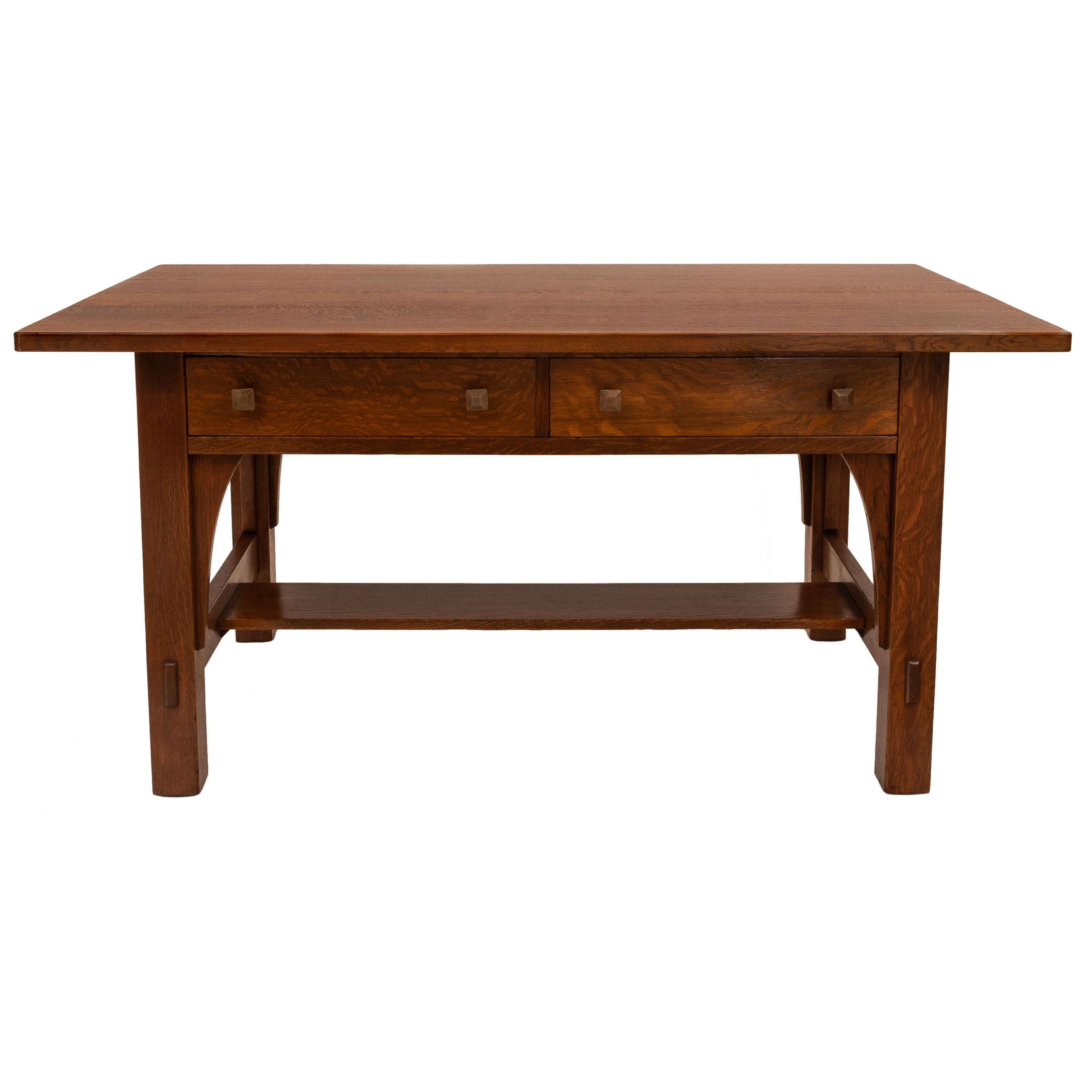 A very good antique American Arts & Crafts, Mission, solid quarter sawn oak library table desk, by Charles P Limbert, circa 1900.
The desk having a overhanging top with twin drawers below, the table raised on four legs with subtle arched supports