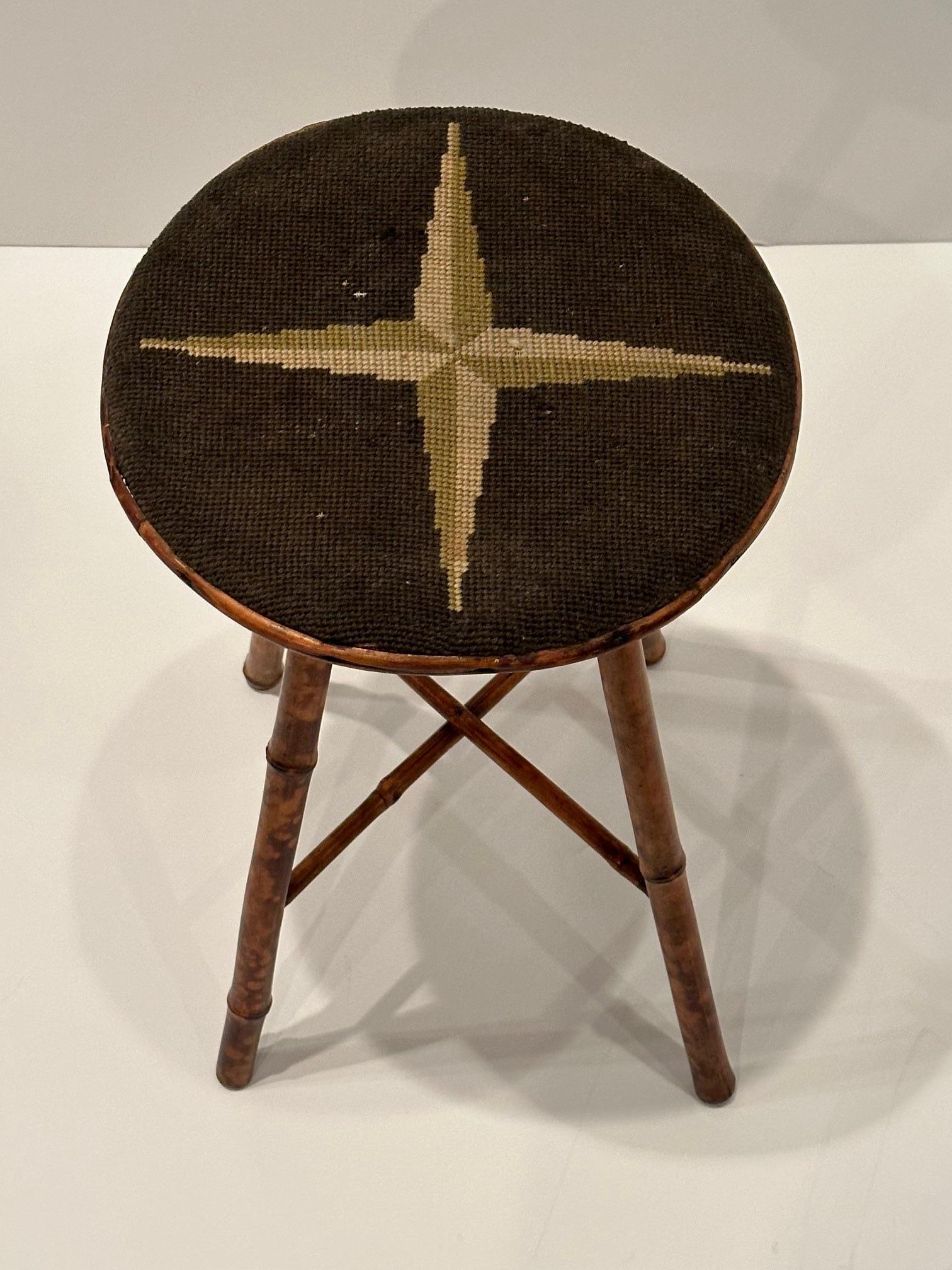 Classic American vintage bamboo stool having original needlepoint seat.